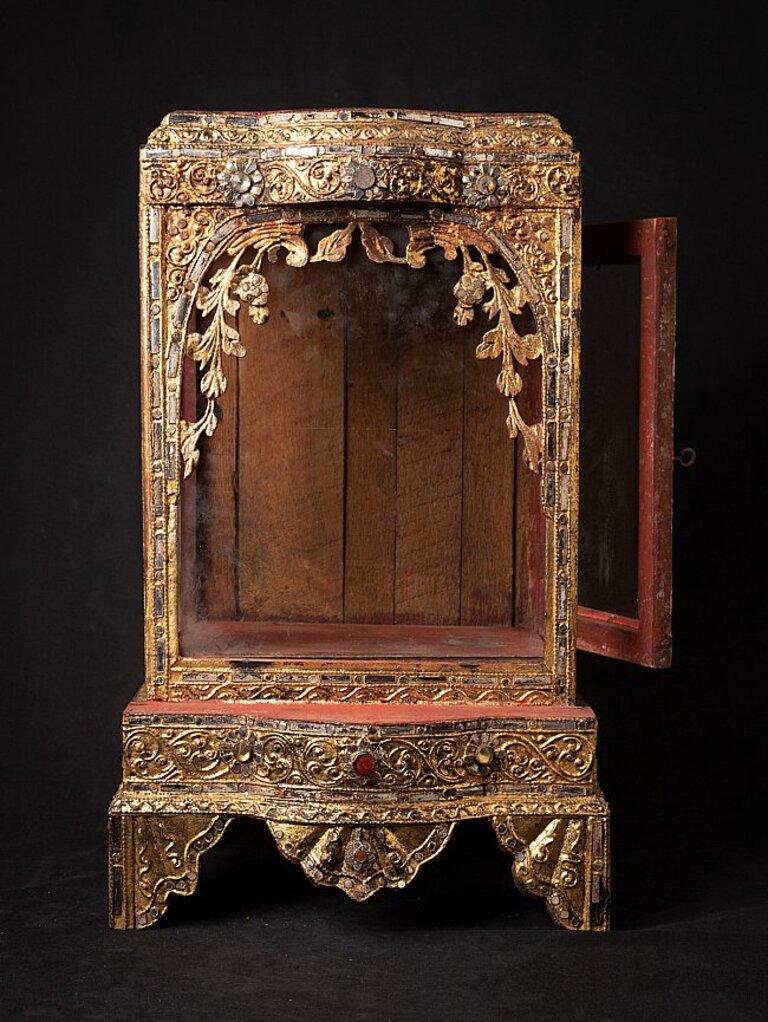 Material: wood
54 cm high 
32,7 cm wide and 27 cm deep
Weight: 3.915 kgs
Gilded with 24 krt. gold
Mandalay style
Originating from Burma
19th century.
 