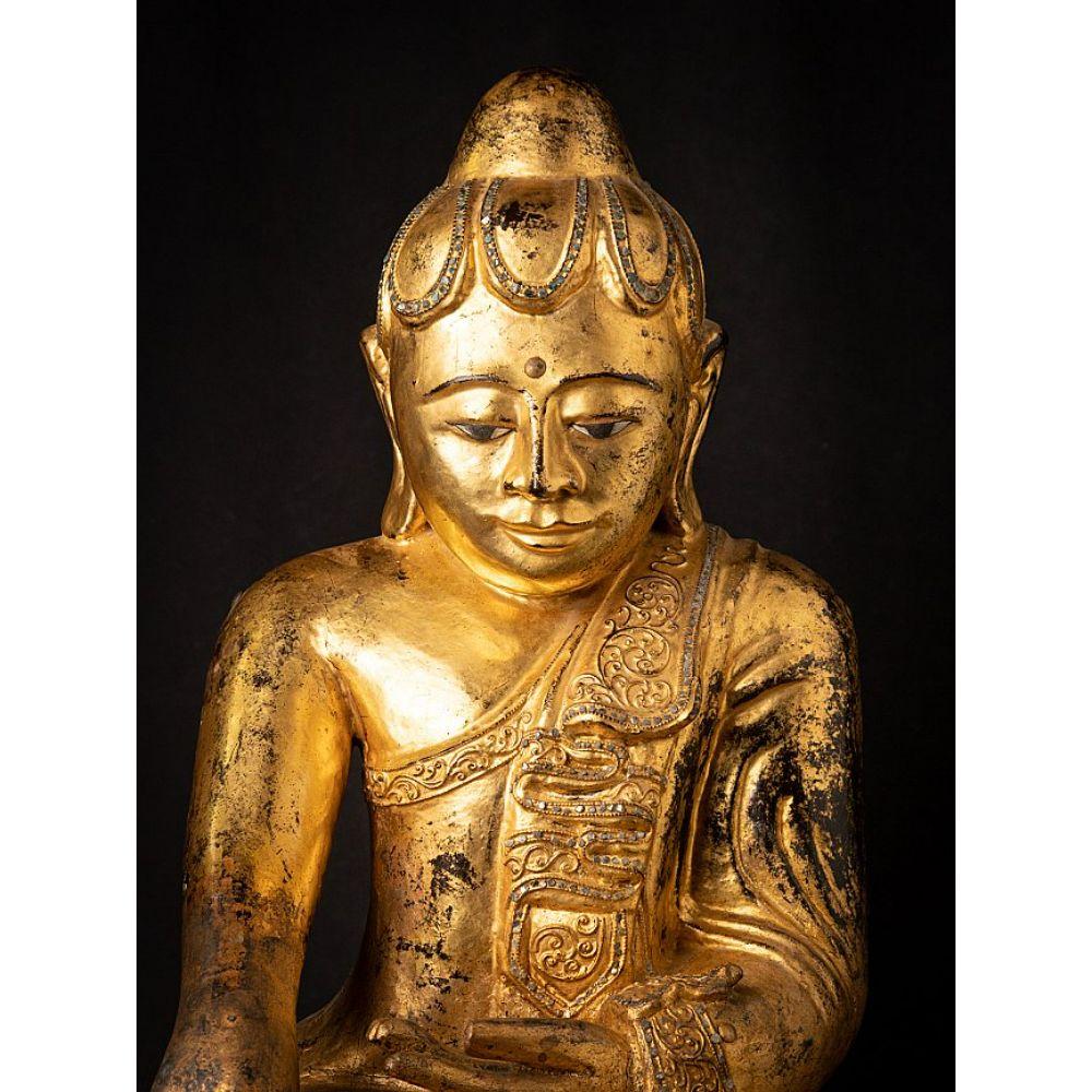 Material: wood
60 cm high 
49 cm wide and 35 cm deep
Weight: 14.80 kgs
Gilded with 24 krt. gold
Mandalay style
Bhumisparsha mudra
Originating from Burma
19th century

