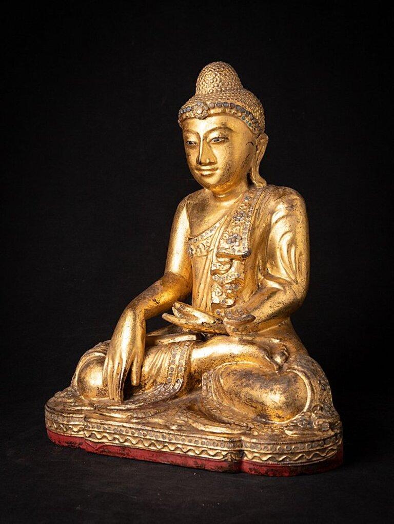Material: wood
Measures: 38 cm high 
31,2 cm wide and 21,3 cm deep
Weight: 3.463 kgs
Gilded with 24 krt. gold
Mandalay style
Bhumisparsha mudra
Originating from Burma
19th century
With inlayed eyes.
  