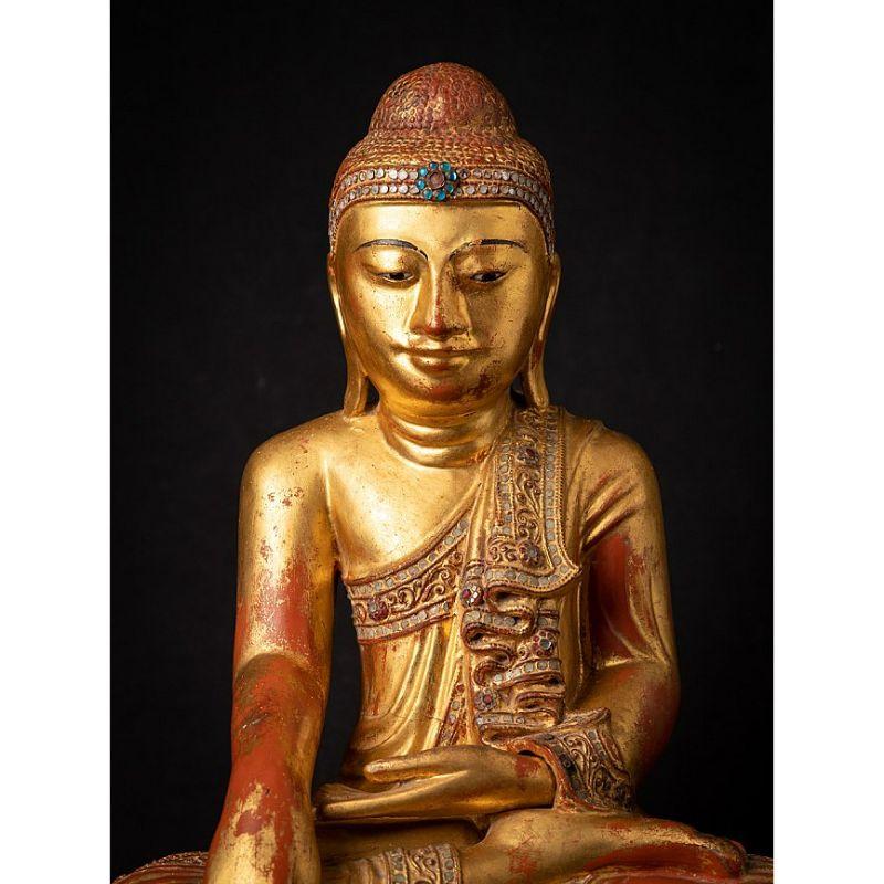Material: wood
Measures: 42 cm high 
36,5 cm wide and 26 cm deep
Weight: 5.632 kgs
Fire gilded with 24 krt. gold
Mandalay style
Bhumisparsha mudra
Originating from Burma
19th century
With inlayed eyes.

