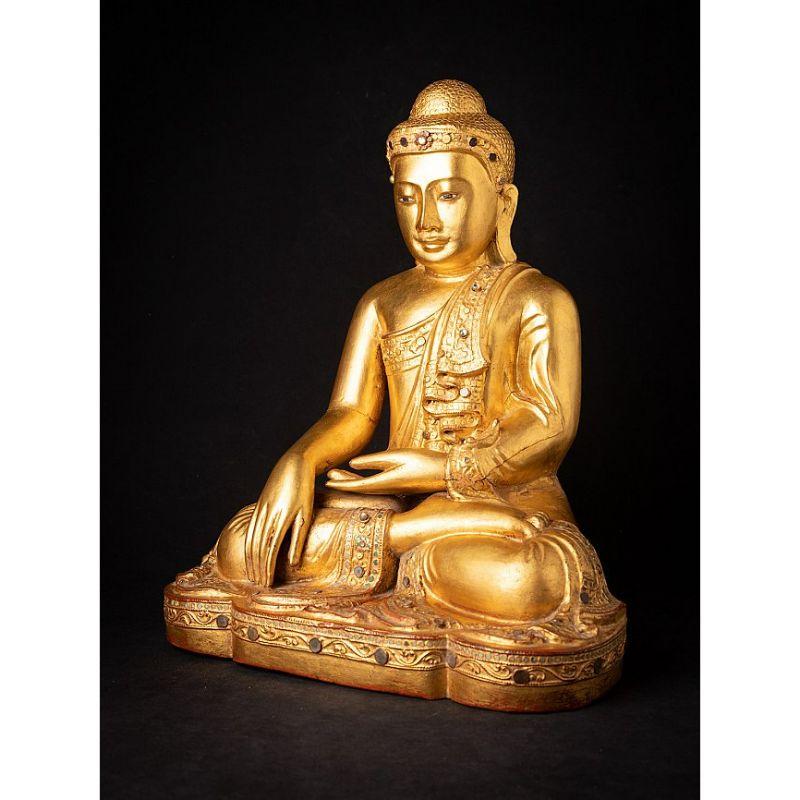 Material: wood
Measures: 45,5 cm high 
37,5 cm wide and 26,5 cm deep
Weight: 6.95 kgs
Gilded with 24 krt. gold
Mandalay style
Bhumisparsha mudra
Originating from Burma
19th century
Regilded with 24 krt. gold in the middle of the 20th