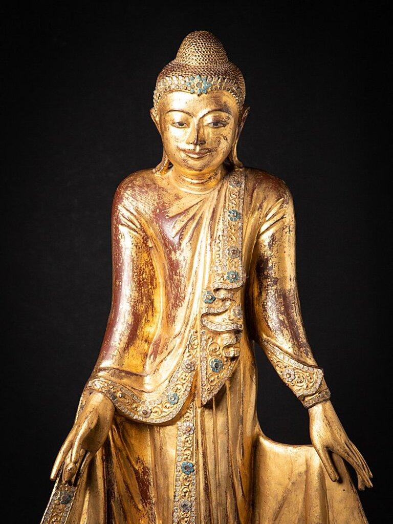 Material: wood
128 cm high 
51 cm wide and 20 cm deep
Gilded with 24 krt. gold
Mandalay style
Originating from Burma
19th century
The height is measured including the 26 cm high wooden base
With inlayed eyes
A very beautiful piece !
 