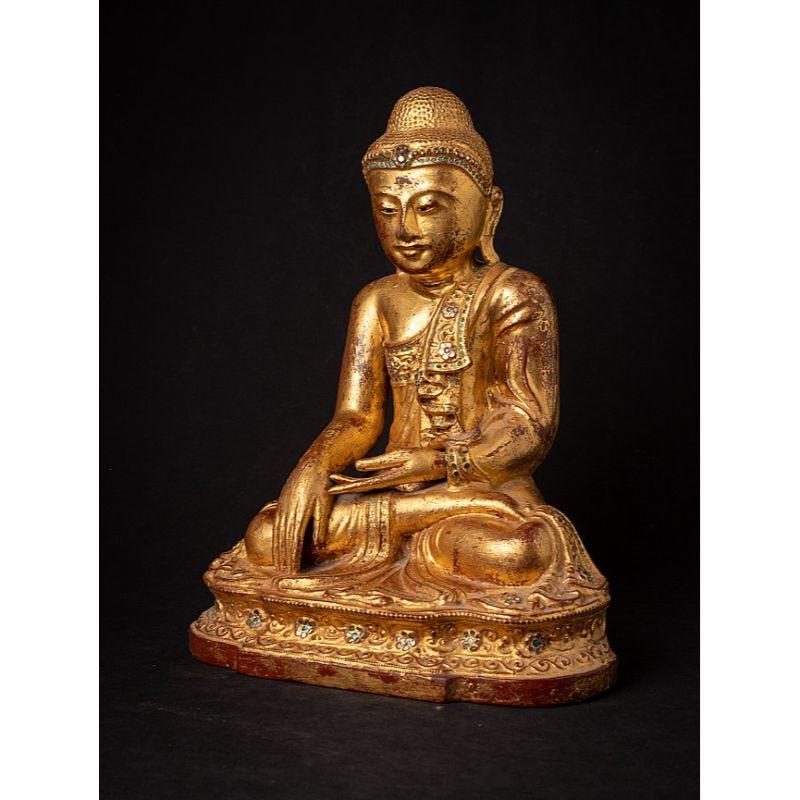 Material: wood
43 cm high 
33,3 cm wide and 23,5 cm deep
Weight: 4.941 kgs
Gilded with 24 krt. gold
Mandalay style
Bhumisparsha mudra
Originating from Burma
19th century
With inlayed eyes

