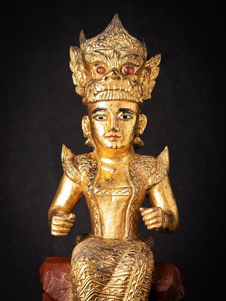 Material: wood
60 cm high 
25 cm wide and 21,7 cm deep
Weight: 6.5 kgs
Gilded with 24 krt. gold
Originating from Burma
Late 19th century
With inlayed eyes
Has normally 'real' flowers in both of her hands.
 