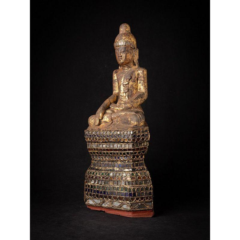 Material: wood
57,5 cm high 
25 cm wide and 16 cm deep
Weight: 5.65 kgs
With traces of 24 krt. gilding
Shan (Tai Yai) style
Bhumisparsha mudra
Originating from Burma
18th Century.

