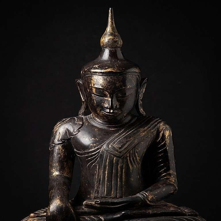 Material: wood
88,5 cm high 
42 cm wide and 28 cm deep
Weight: 15.15 kgs
With traces of 24 krt. gold
Shan (Tai Yai) style
Bhumisparsha mudra
Originating from Burma
18th century
