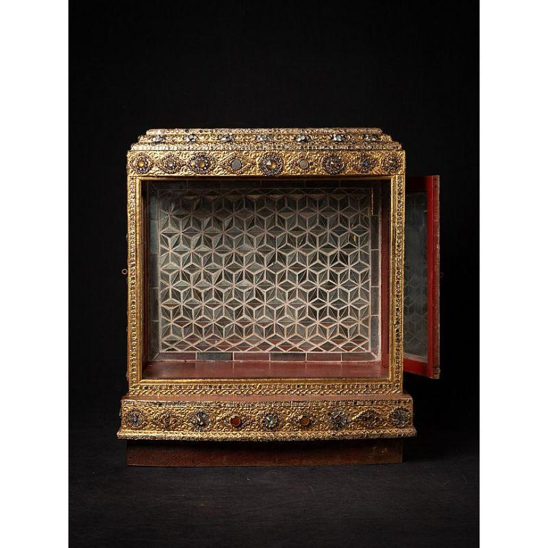 Material: wood
64,2 cm high 
57,5 cm wide and 35 cm deep
Gilded with 24 krt. gold
Mandalay style
Originating from Burma
Late 19th century
With a door on both sides
The back wall consists of many small mirrors

