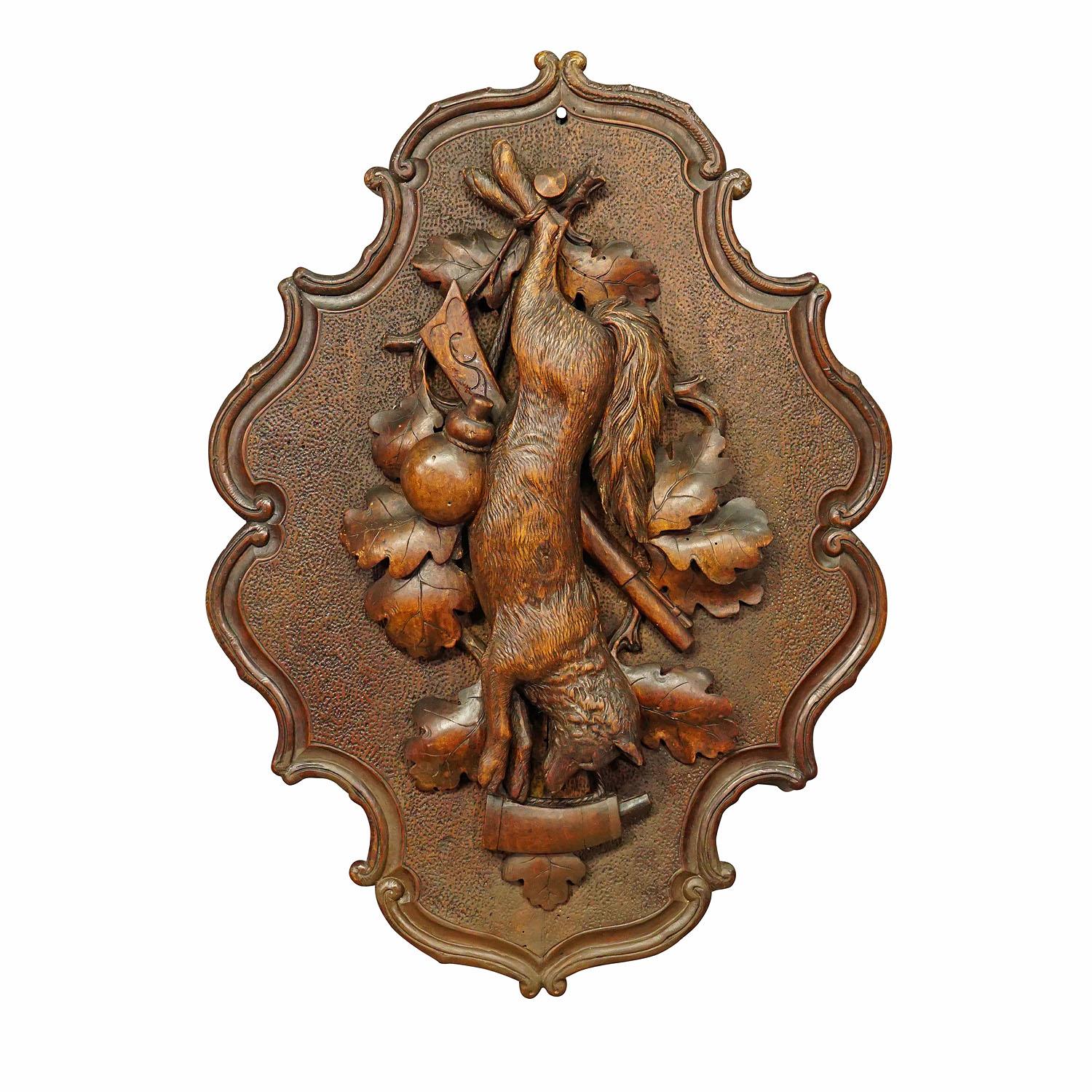 Antique wooden carved black forest game plaque with fox.

An antique wooden hunting game plaque with impressive carving of a fox and hunting accessoires. Black Forest, executed ca. 1900. Very good condition. This plaque is a splendid addition to