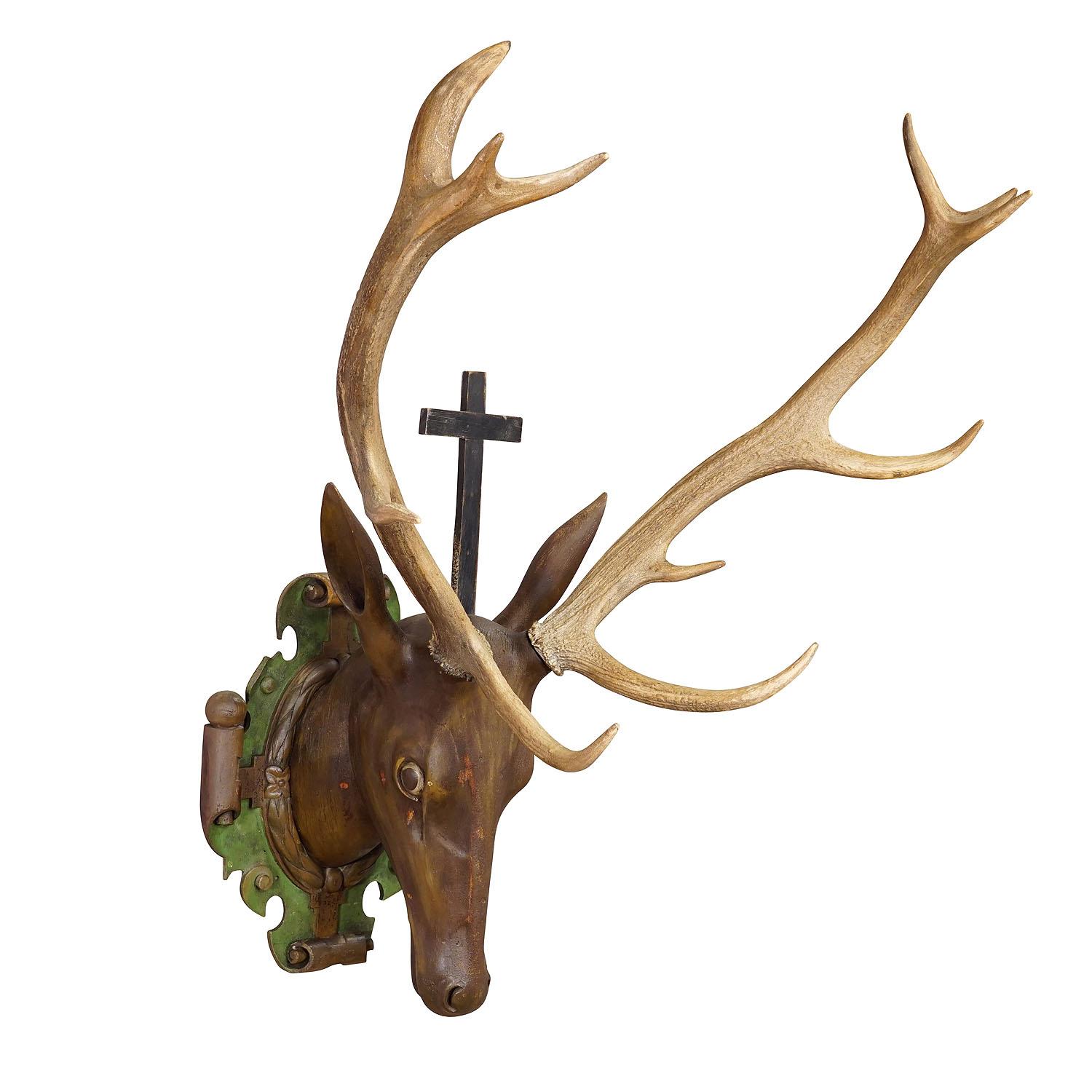 Large Antique Wooden Carved Black Forest Baroque stag head with 10 Point Trophy

A large antique Black Forest baroque stag head. Carved in typical abstract style of the early 18th century. It is mounted on a wooden carved and painted plaque with