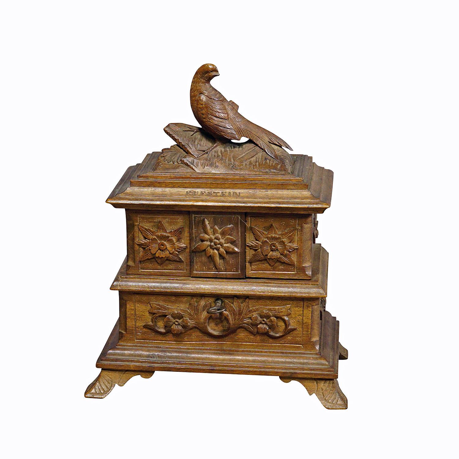 Antique Wooden Carved Edelweis Jewelry Box with Bird, Brienz ca 1900

A very nice antique handcarved Black Forest sewing box or jewelry box with edelweis carvings and bird on the lid. The inside is covered with blue velvet. The item is a fine