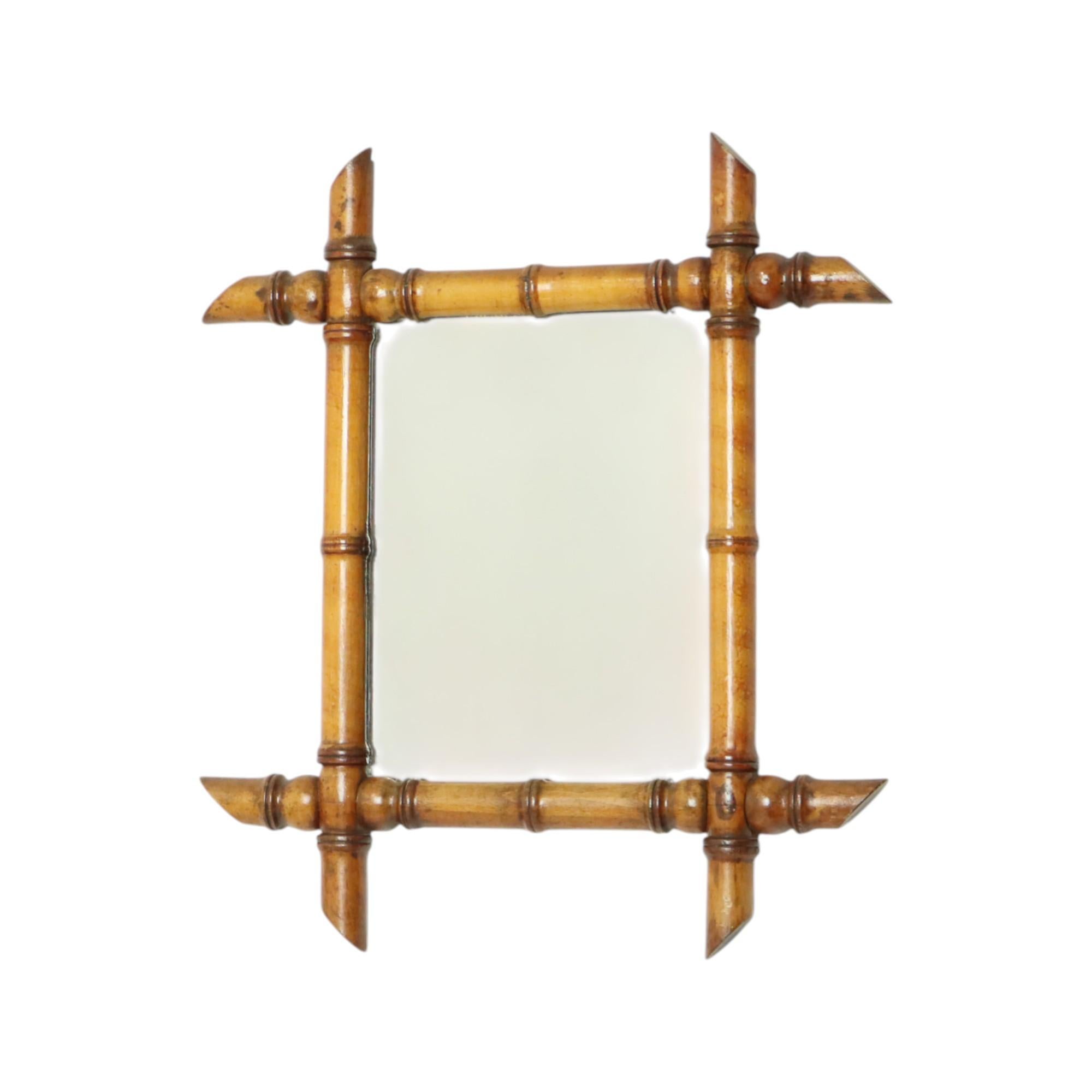 Antique faux bamboo mirror with original mirror plate and planked back, entirely in Chinoiserie style. This style was very popular during the Art Nouveau period. Originally from France, this example dates from around 1900.

This beautiful wooden