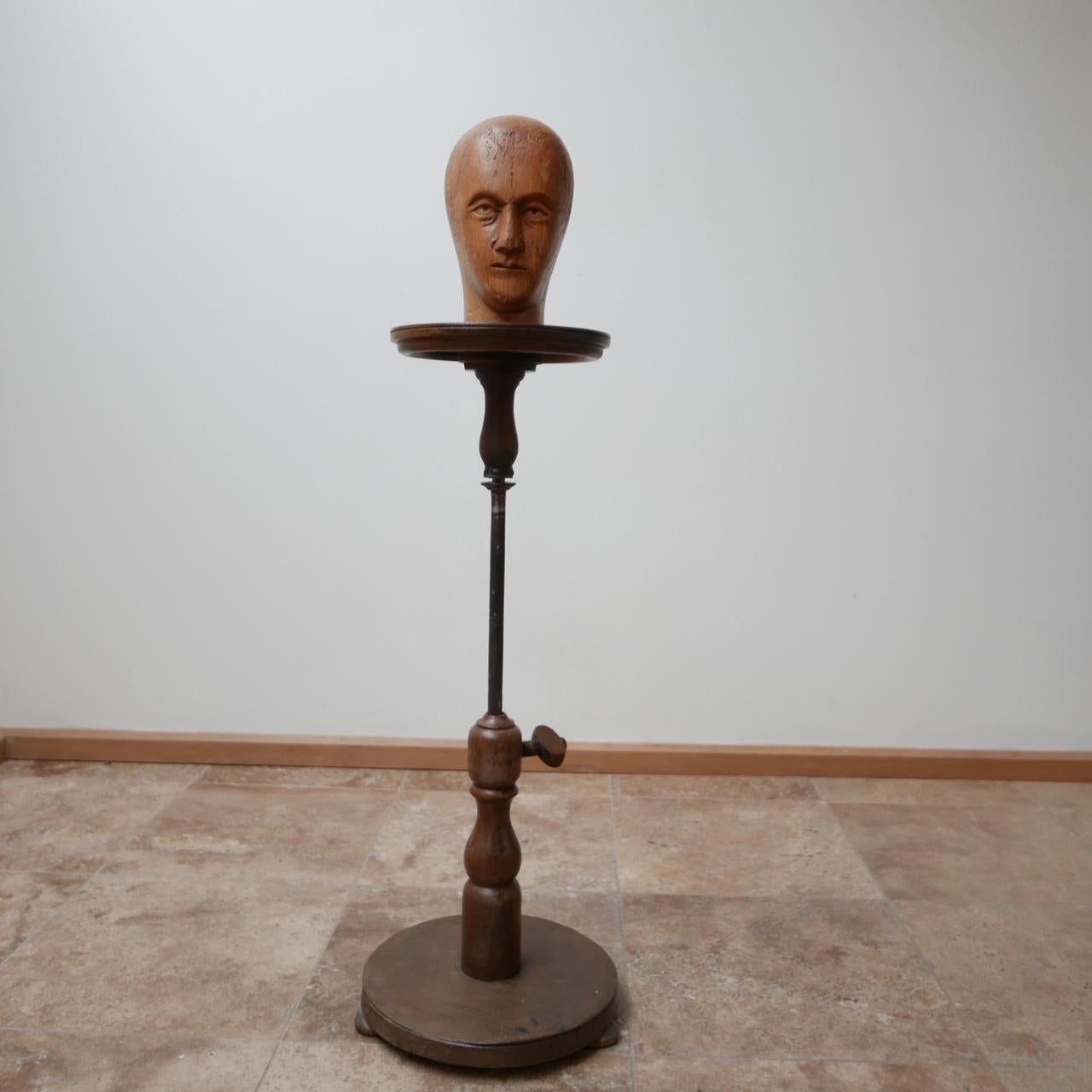 An adjustable artists sculpture stand.

French, circa 1930s.

Turned wooden top, base with a metal adjustable central stand.

Ideal for art display or as a side lamp.

Etched label to the turned peg, faintly showing 'Mandonnaud