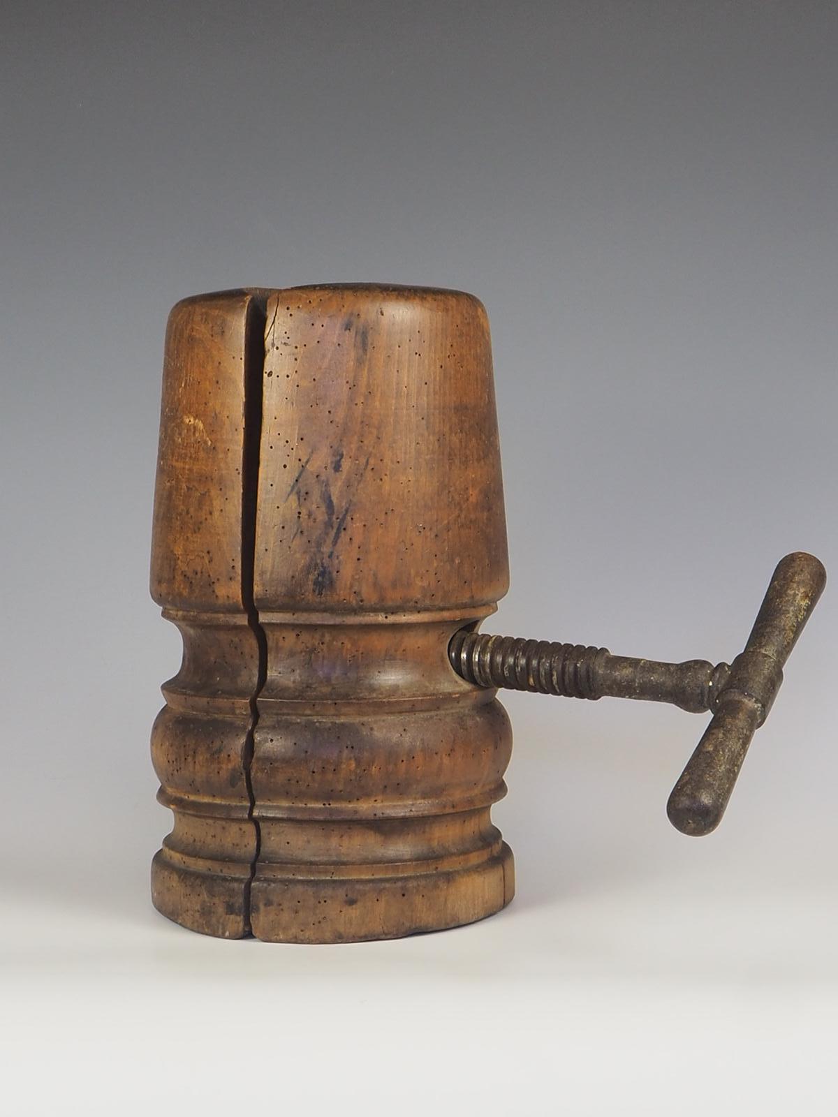 Mid to late 19th century adjustable milliners hat stretcher/block.

A wonderful & early piece made from a single lump of hardwood with a fantastic grain & depth of colour. An exceptional example, finished with some beautiful metalwork & a patinated