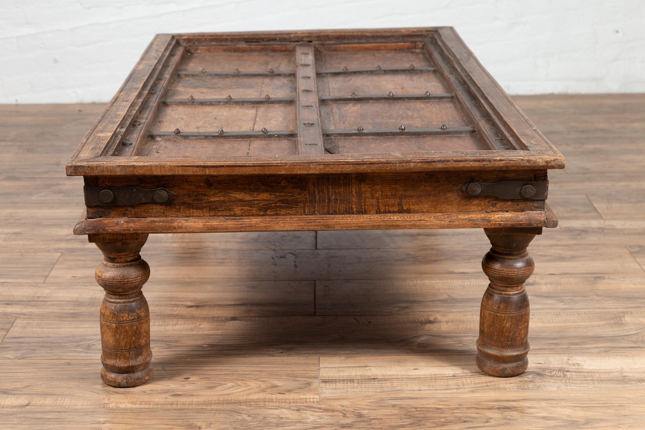 Antique Wooden Indian Palace Door Made into a Coffee Table with Iron Braces In Good Condition In Yonkers, NY