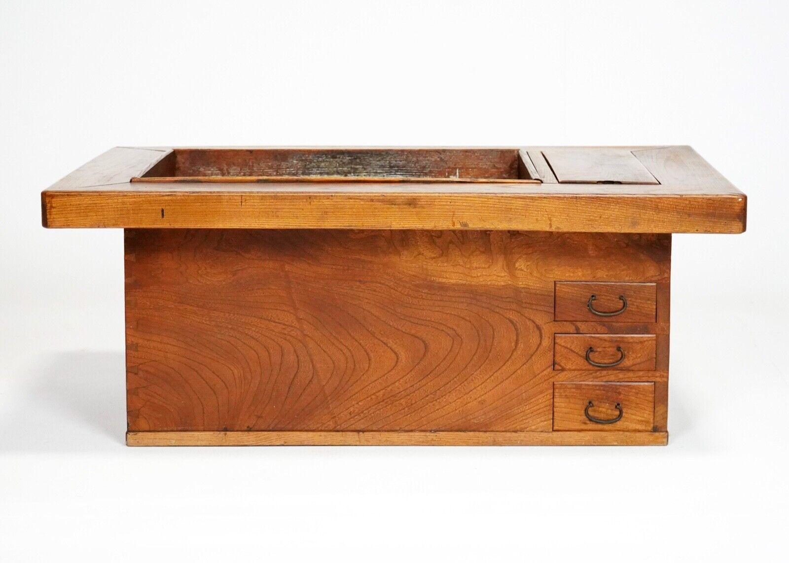 Antique Japanese hibachi from the Kyoto region, made from elm circa 1900.
Used originally to heat drinks and generally keep the room warm, now repurposed as a coffee table.
 It has a copper lined box where you'd originally have your coals, it'd be