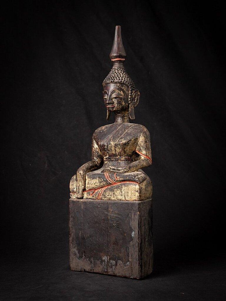 Material: wood
54,5 cm high 
18,5 cm wide and 12,5 cm deep
Weight: 3.166 kgs
With traces of the original 24 krt. gilding
Bhumisparsha mudra
Originating from Laos
18th century
Tai Lue style
Very high quality !
 