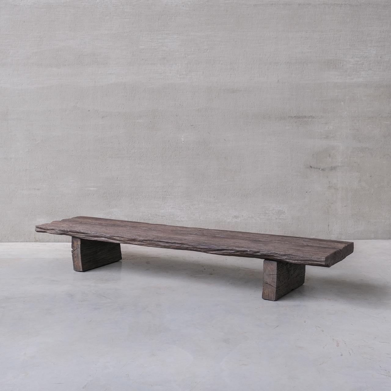 A long low coffee table. 

France, c1930s. 

Formed from antique wood into a new proposition. 

Undulating natural wooden surface in wabi sabi style. 

Stained finish. 

Internal reference: 12/9/23/015

Location: Belgium Gallery. 

Dimensions: 33.5