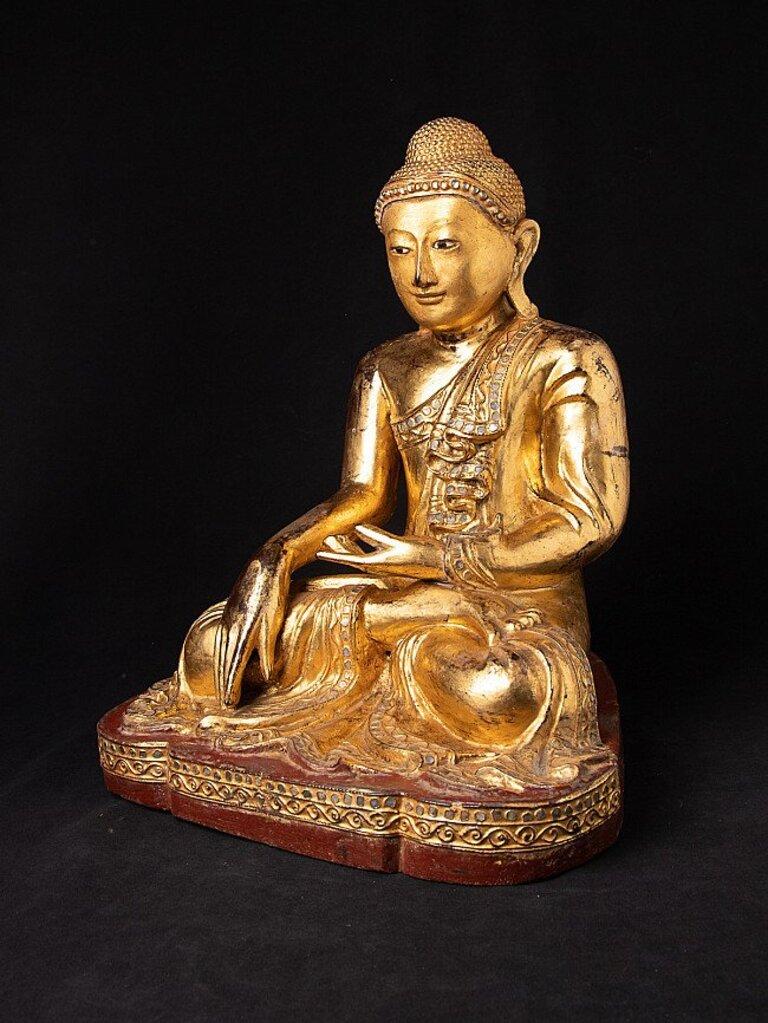 Material: wood
43,8 cm high 
35 cm wide and 29,3 cm deep
Weight: 6.45 kgs
Gilded with 24 krt. gold
Mandalay style
Bhumisparsha mudra
Originating from Burma
19th century
With inlayed eyes.
 