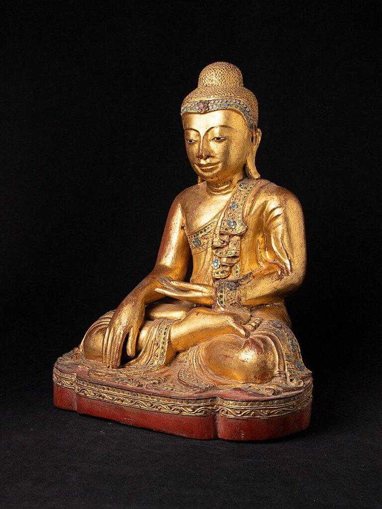 Material: wood
48,9 cm high 
38,2 cm wide and 28,2 cm deep
Weight: 8.4 kgs
Gilded with 24 krt. gold
Mandalay style
Bhumisparsha mudra
Originating from Burma
19th century
With inlayed eyes

