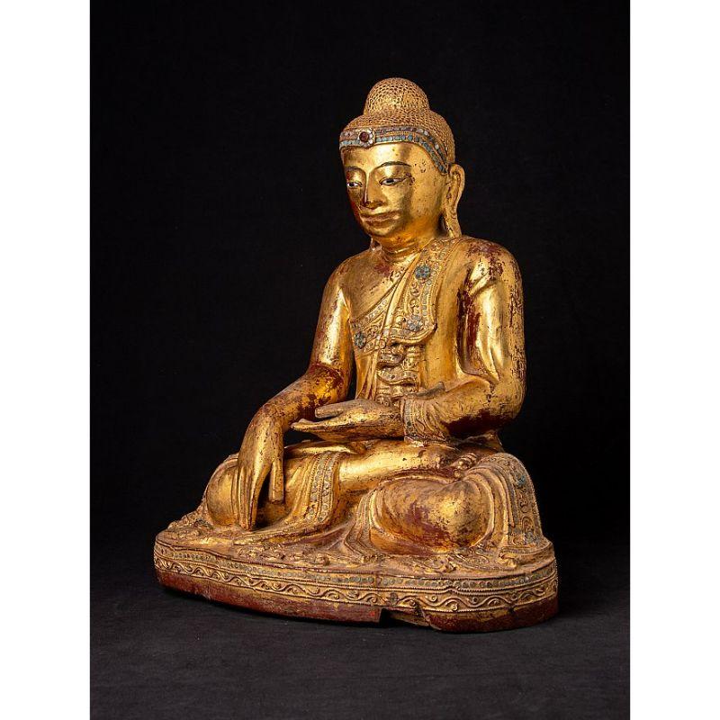 Material: wood
43,5 cm high 
35,4 cm wide and 24,5 cm deep
Weight: 5.75 kgs
Gilded with 24 krt. gold
Mandalay style
Bhumisparsha mudra
Originating from Burma
19th century
With inlayed eyes.

