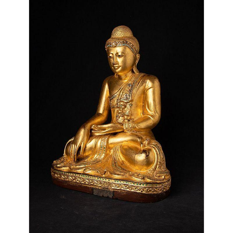 Material: wood
47,2 cm high 
37 cm wide and 26,2 cm deep
Weight: 7.1 kgs
Gilded with 24 krt. gold
Mandalay style
Bhumisparsha mudra
Originating from Burma
19th century
With inlayed eyes.


