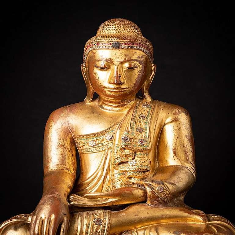Material: wood
48,7 cm high 
35 cm wide and 25,6 cm deep
Weight: 6.8 kgs
Gilded with 24 krt. gold
Mandalay style
Bhumisparsha mudra
Originating from Burma
19th century
With inlayed eyes
