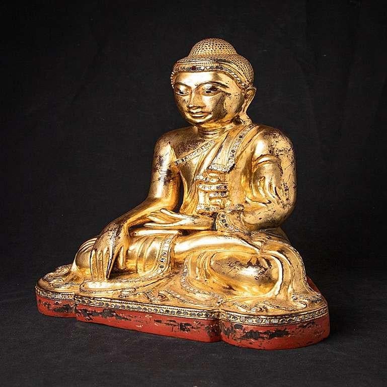 Material: wood
41,9 cm high 
34,3 cm wide and 24,3 cm deep
Weight: 5.45 kgs
Gilded with 24 krt. gold
Mandalay style
Bhumisparsha mudra
Originating from Burma
19th century
With inlayed eyes.
 