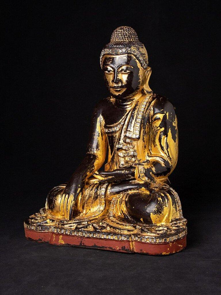 Material: wood
35,8 cm high 
28,7 cm wide and 20,5 cm deep
Weight: 3.05 kgs
Gilded with 24 krt. gold
Mandalay style
Bhumisparsha mudra
Originating from Burma
19th century
With inlayed eyes
