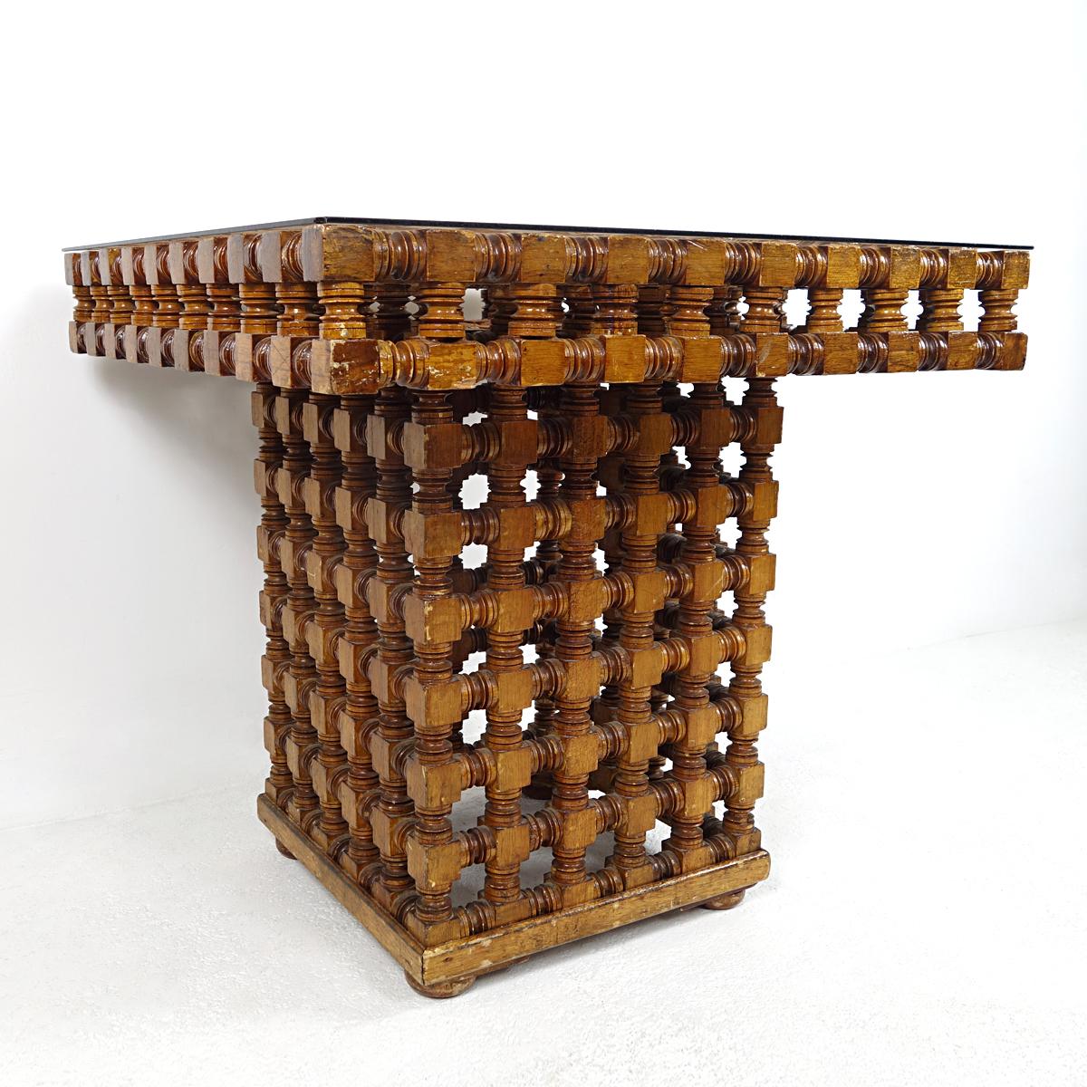 Moroccan coffee table handmade in the beginning of the 20th century.
The carved wood is a representation of the ancient Mashrabiya style, characteristic of traditional architecture in the Islamic world, used to keep the sun out and let the wind in.