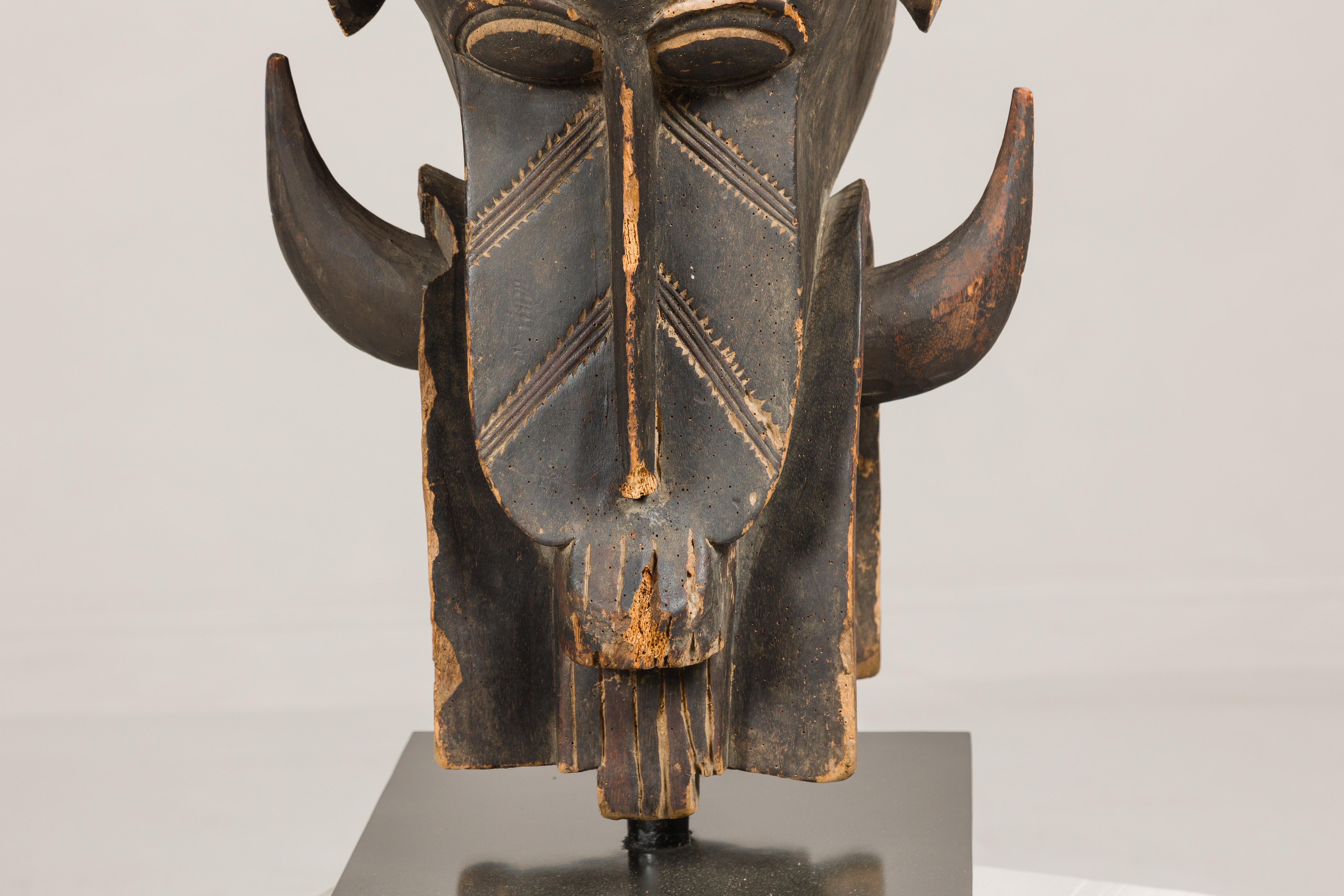 Primitive Antique Wooden Mythical Animal Mask Mounted on Black Lacquer Base For Sale