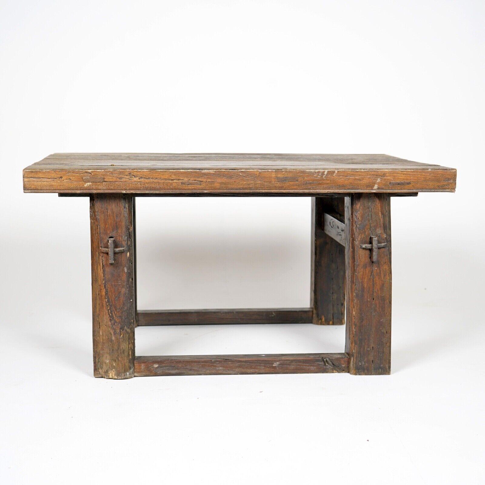 A antique primitively made wooden coffee table. 
The chunky three plank top, sits on-top of solid legs and stretchers, held together with peg joints.
The design is bold and the straight lines are in contrast with the grain in the wood, I think it