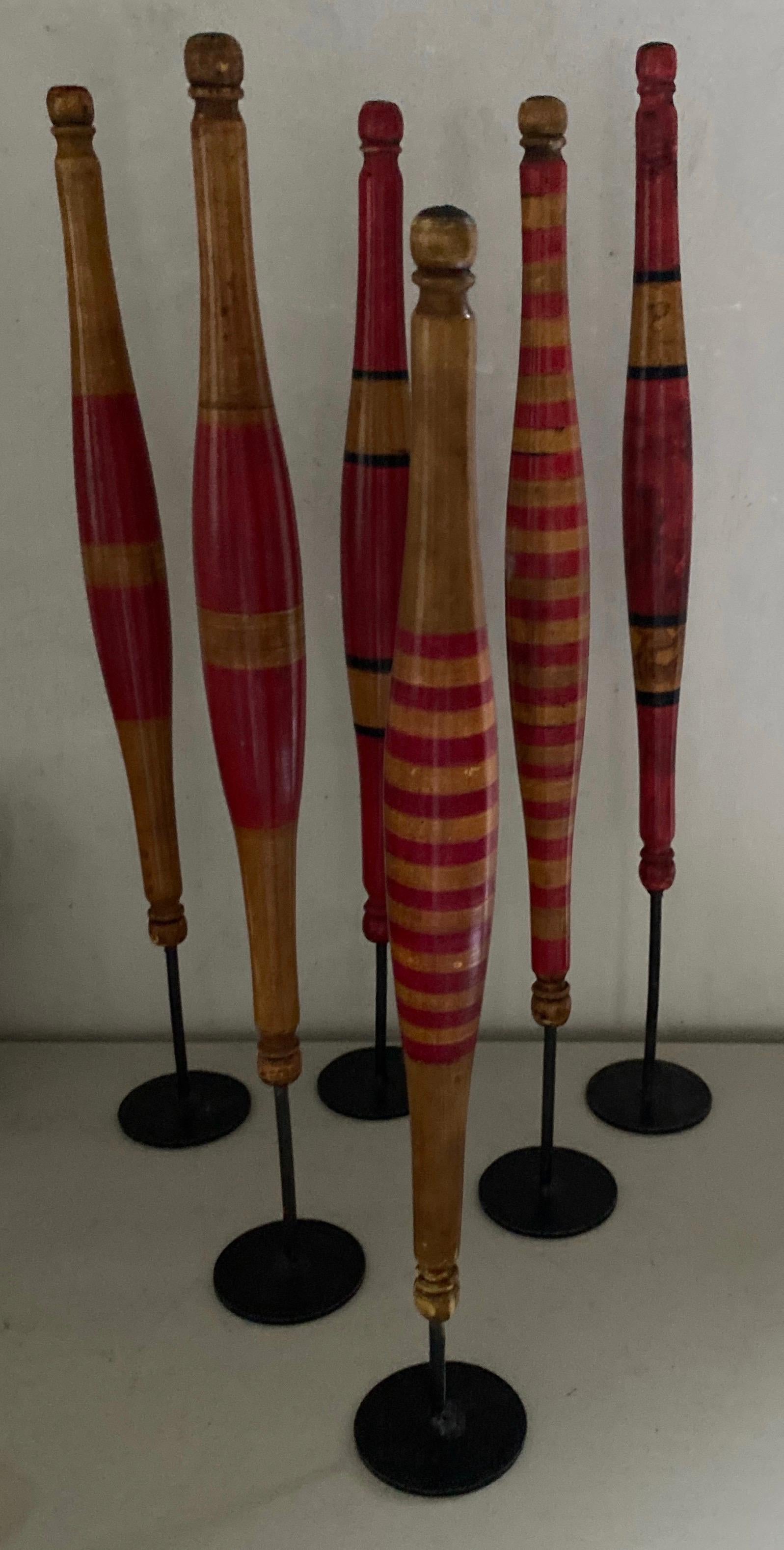 A collection of 6 rare brightly painted wood spindles for hand spinning yarn mounted on metal stands creating a wonderful sculptural display. Each one slightly different. The group makes a fun display on any surface.
Dimensions provided is for the