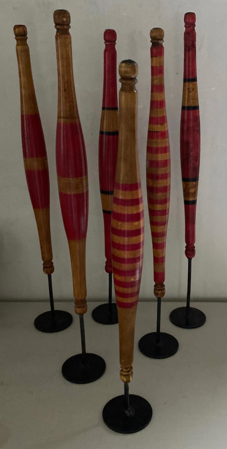A collection of 6 rare brightly painted wood spindles for hand spinning yarn mounted on metal stands creating a wonderful sculptural display. Each one slightly different. The group makes a fun display on any surface.
Dimensions provided is for the