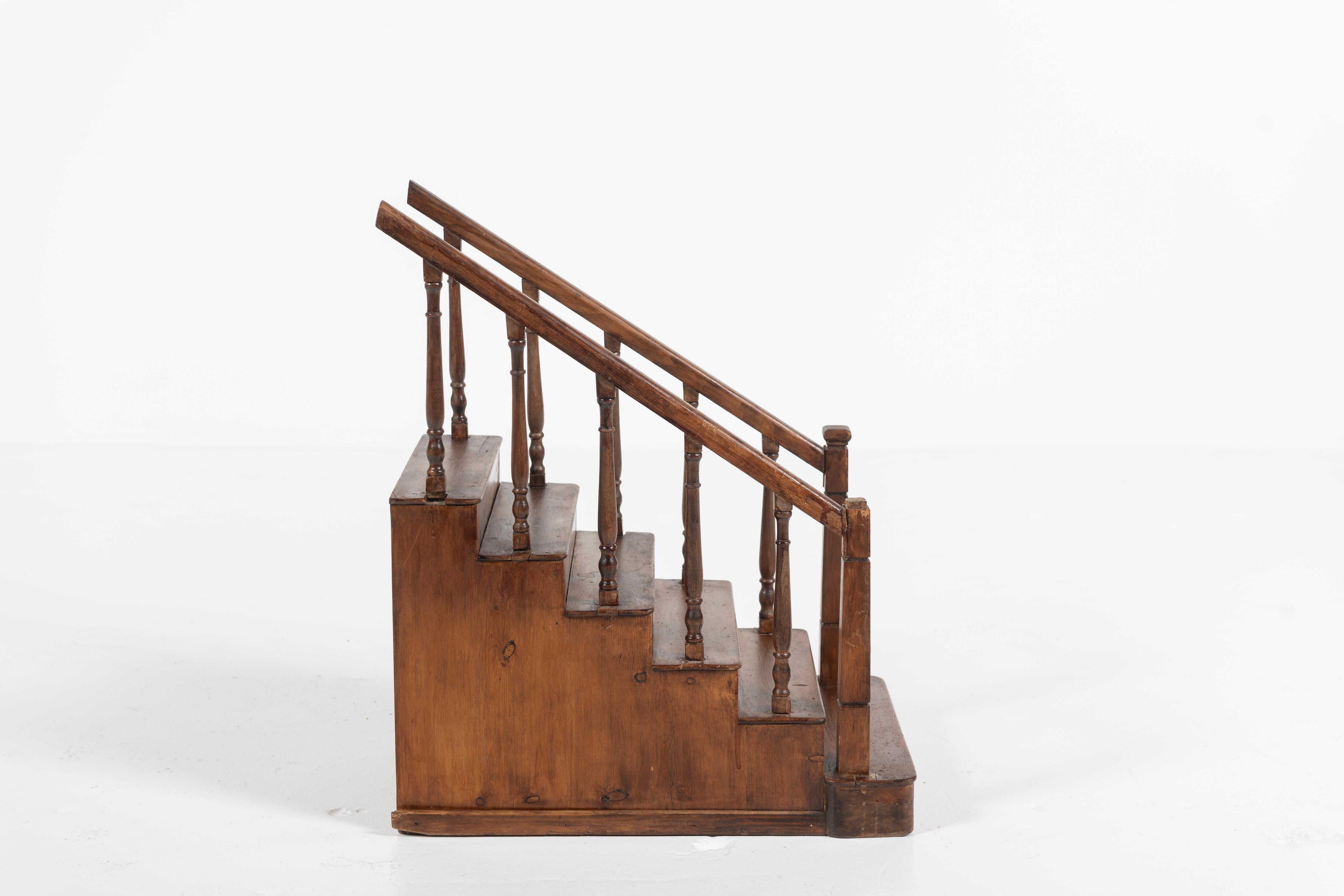 This lovely diminutive English staircase model from the 1920's is certain to add interest to doll houses and playlands of every scale. The model is of traditional design and carved of walnut.