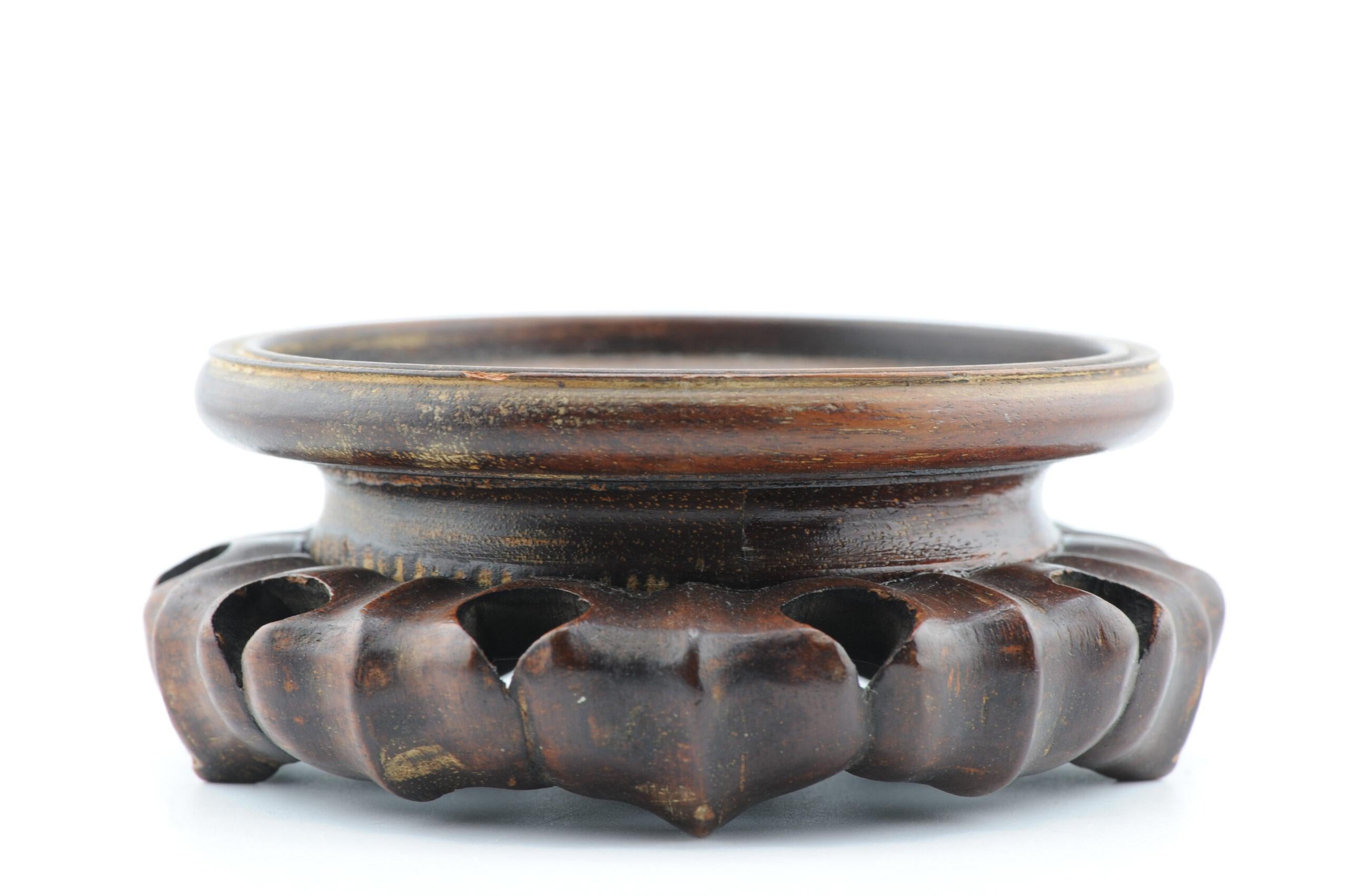 Aquí tenemos un bonito soporte de madera

Más información:
Material: Porcelana y cerámica
Región de origen: China
Periodo: s. XIX / principios del s. XX
Estado: Un poco desgastado
Dimensiones: Tamaño de la superficie útil: 9.5 cm