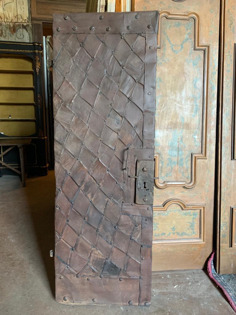 Ancient entrance door, coming from a tower, is made up of wood covered with iron scales, this method of construction of the door was used to repair the wood from salt and humidity, they were often placed in places by the sea or with a lot of