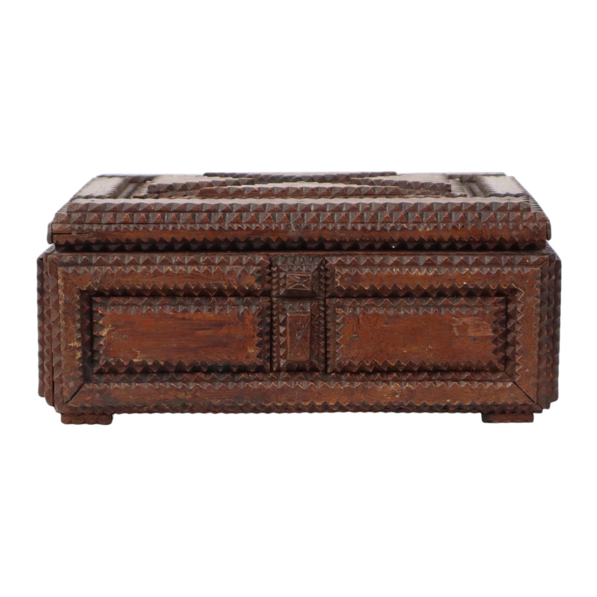 Antigua caja de madera rectangular de arte vagabundo con ojo de cerradura oculto, paneles elaboradamente decorados, teñida de marrón oscuro. Pieza de coleccionista de arte popular con una hermosa pátina de envejecimiento de principios del siglo