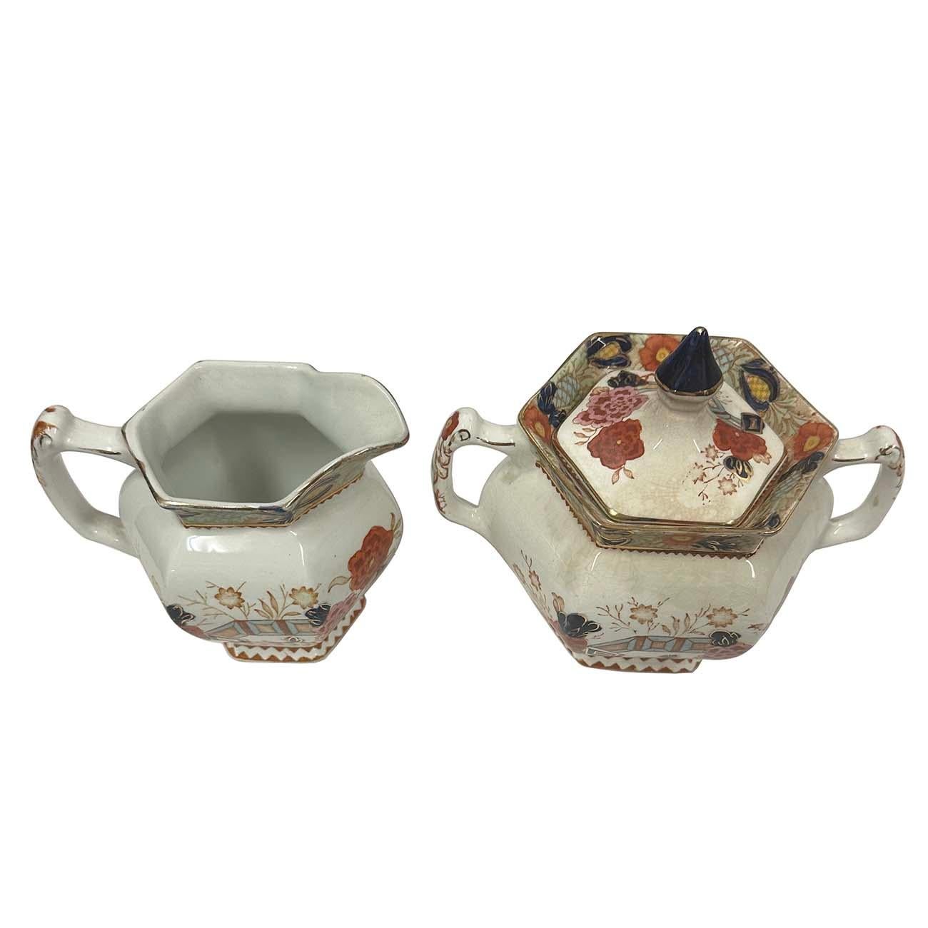 Stunning porcelain creamer and lidded sugar bowl by Wood & Sons Woods Ware in the Wincanton Blue and Rust pattern, in about 1885s with Mark stamps on the bottom. Pattern features a brown transfer Imari style pattern with hand-painted accents in