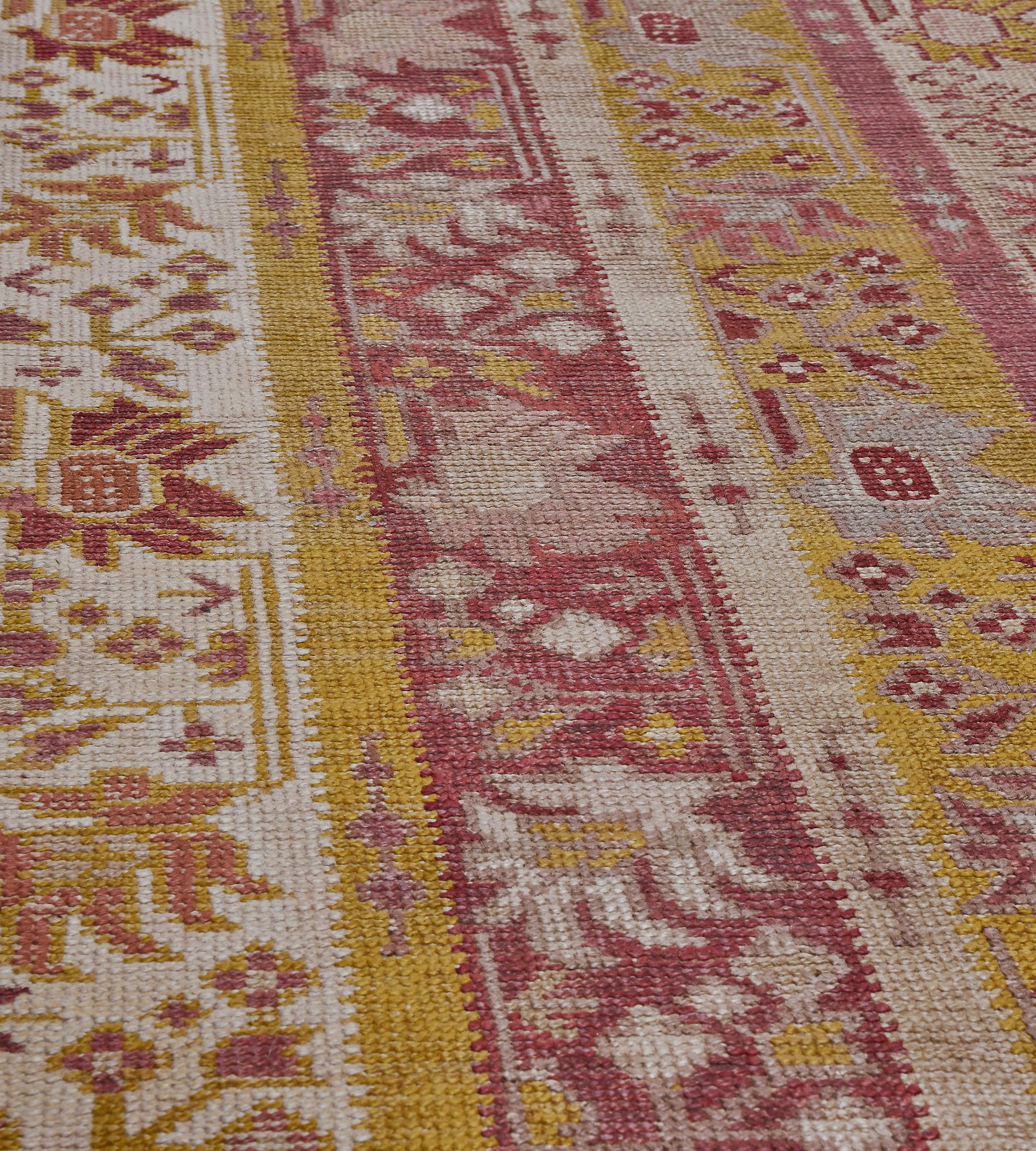 Questo antico runner turco ha un campo con tre colonne verticali di colore avorio, giallo sabbia e rosso lampone, ognuna delle quali contiene un tralcio di fiori angolare, tra tre strisce minori contenenti spruzzi di fiori distanziati tra loro, con