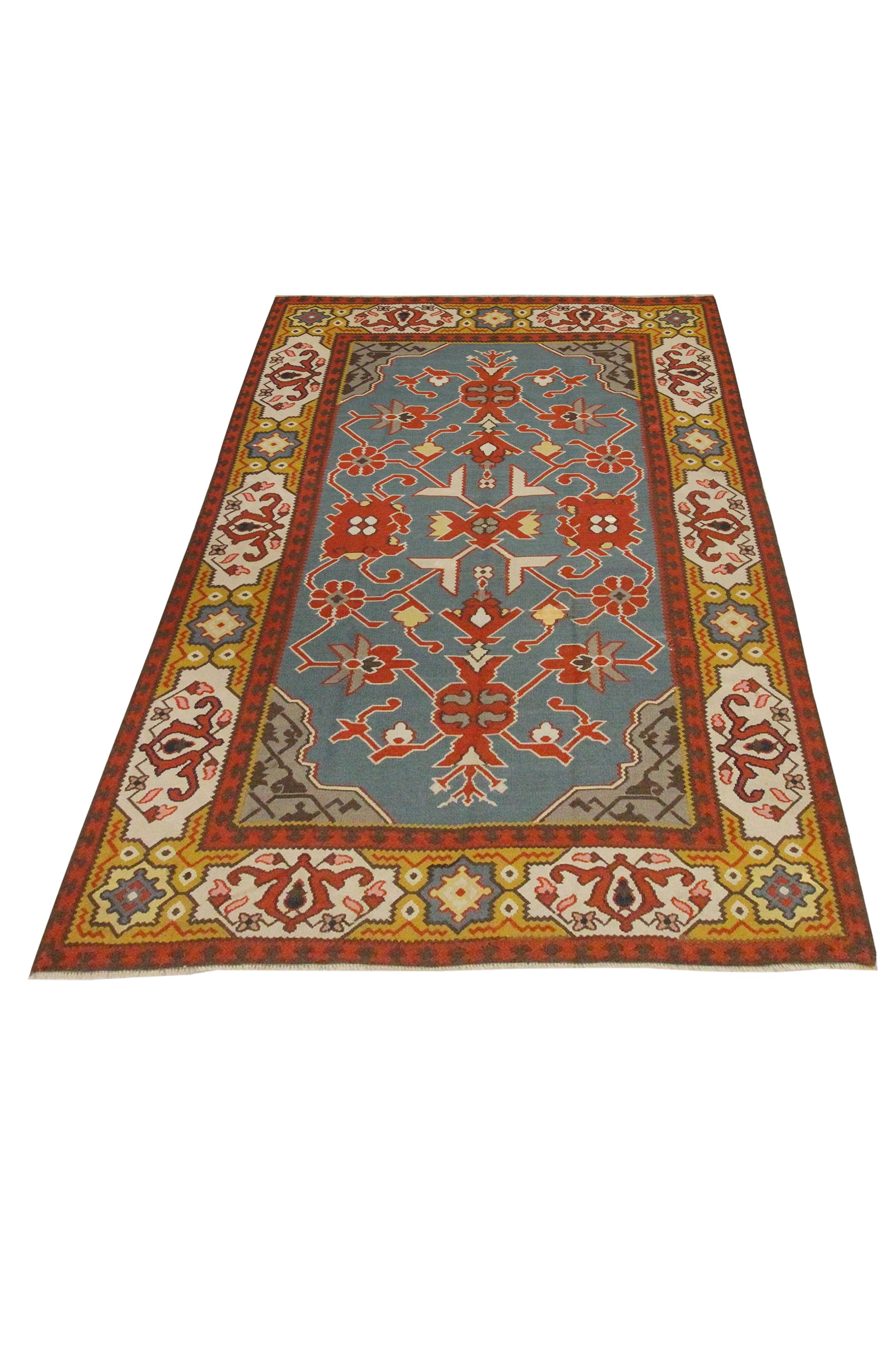 This bold oriental Kilim is a great example of antique kilims. The central design has been woven in blue, red and yellow accents that make up the decorative symmetrical floral motif design. Oriental rugs can be used as an accent accessory to