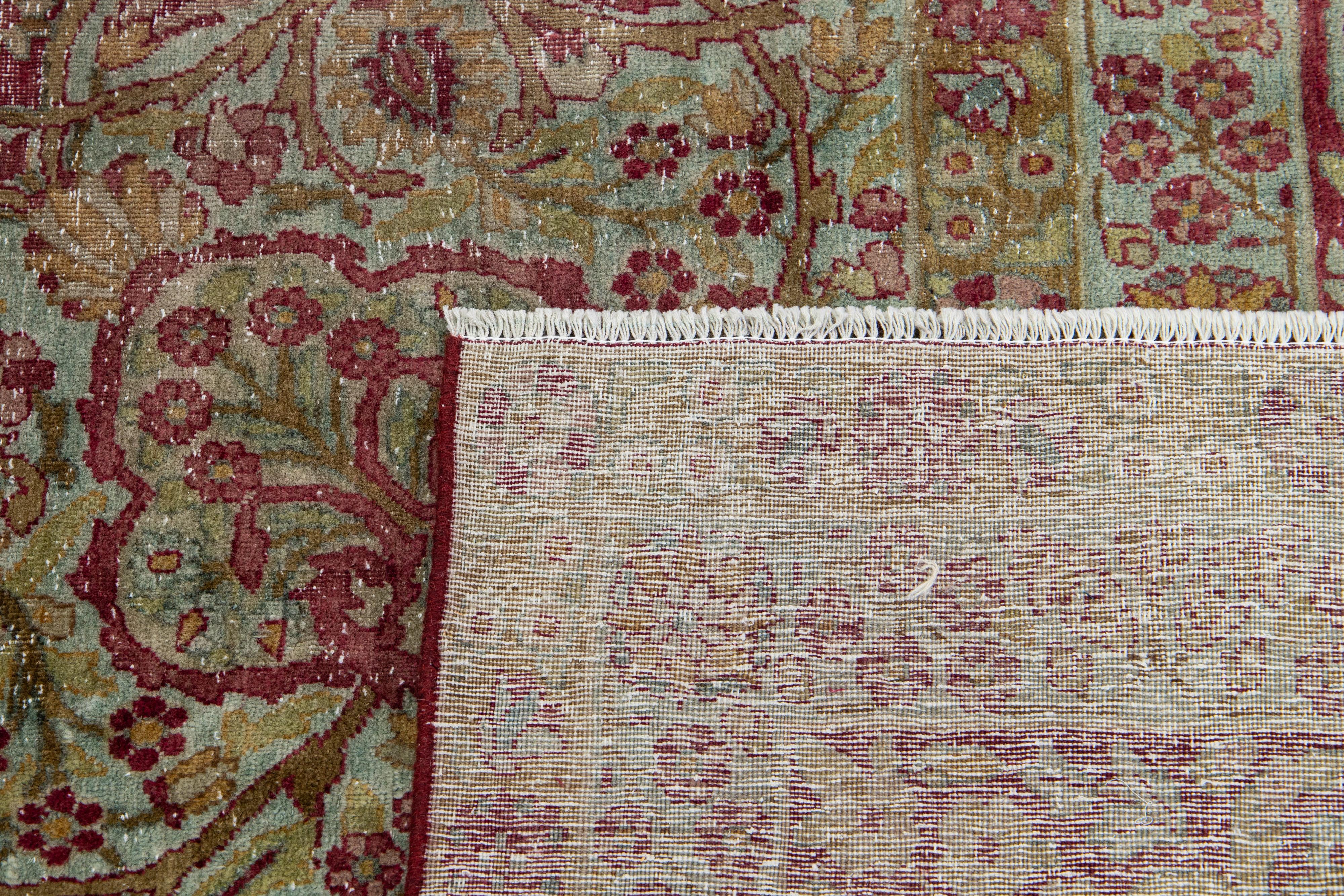 Hand-Knotted Antique Wool Rug Persian Kerman featuring a Medallion Floral Motif  For Sale