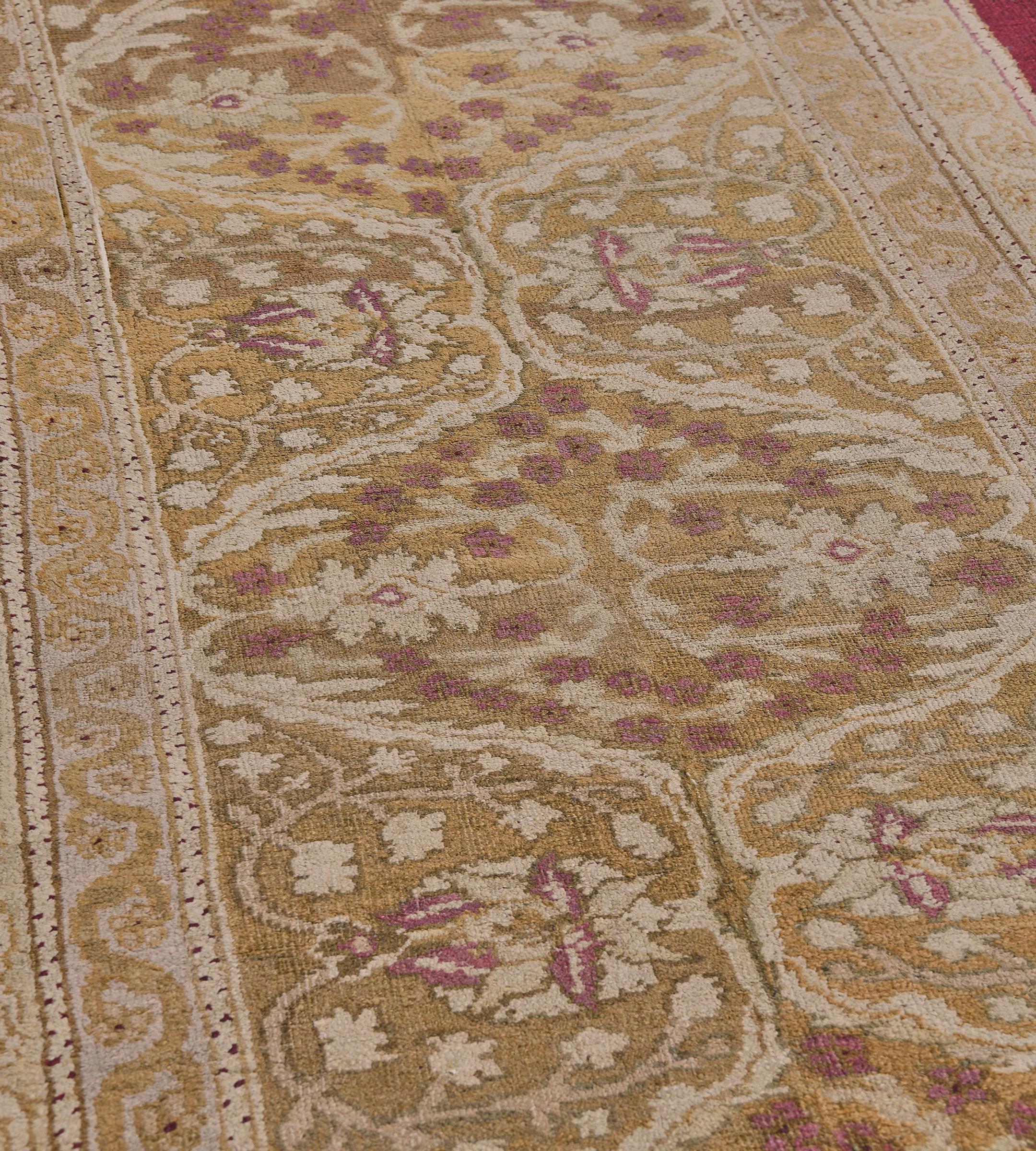 Cette antique coulisse d'Agra présente un champ jaune safran avec de délicates palmettes ivoire et rouge framboise et une vigne florale autour d'une colonne de six losanges liés jaune pistache, chacun avec une bande florale circulaire et une paire