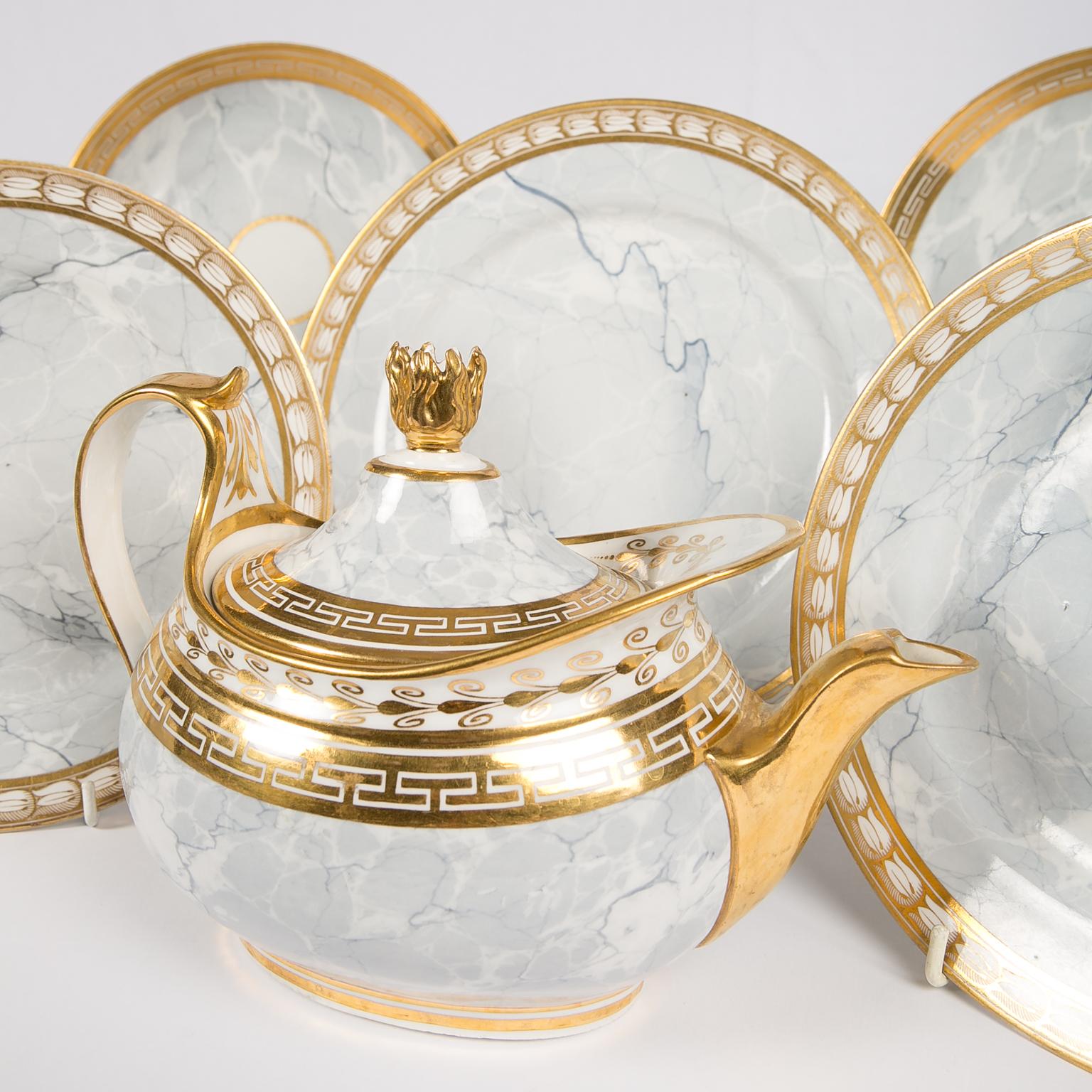 Antique Worcester marbled grey teapot with part tea service made between 1807-1813.  An extraordinary light grey marbled pattern (see images) decorates this collection with the exceptional teapot being the highlight. 
Its brightly gilded flame