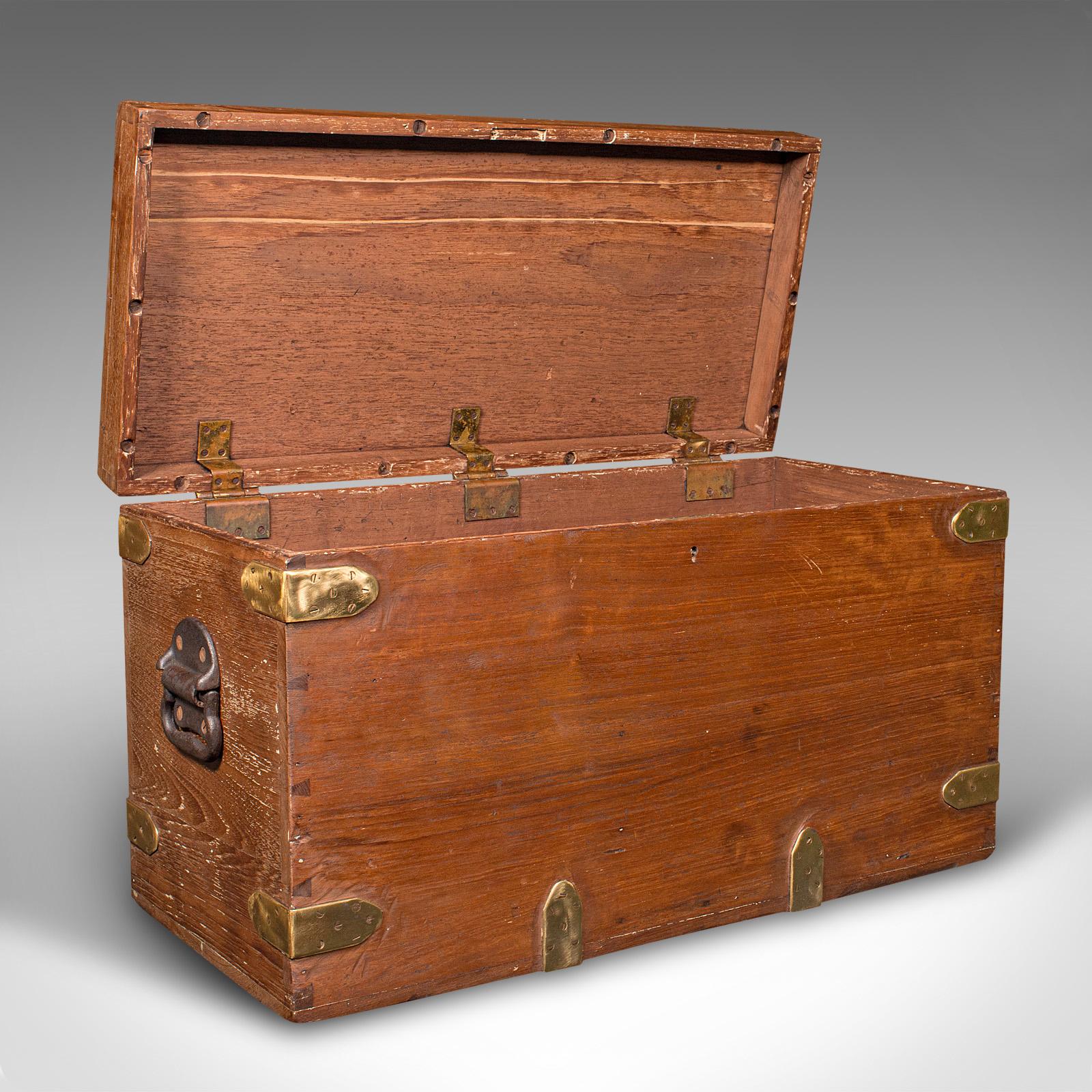 This is an antique workman's tool chest. An English, teak and brass capped craftsman's trunk, dating to the late Victorian period, circa 1880.

Delightfully time-worn chest with a robust appeal
Displays a desirable aged patina throughout
Teak stocks