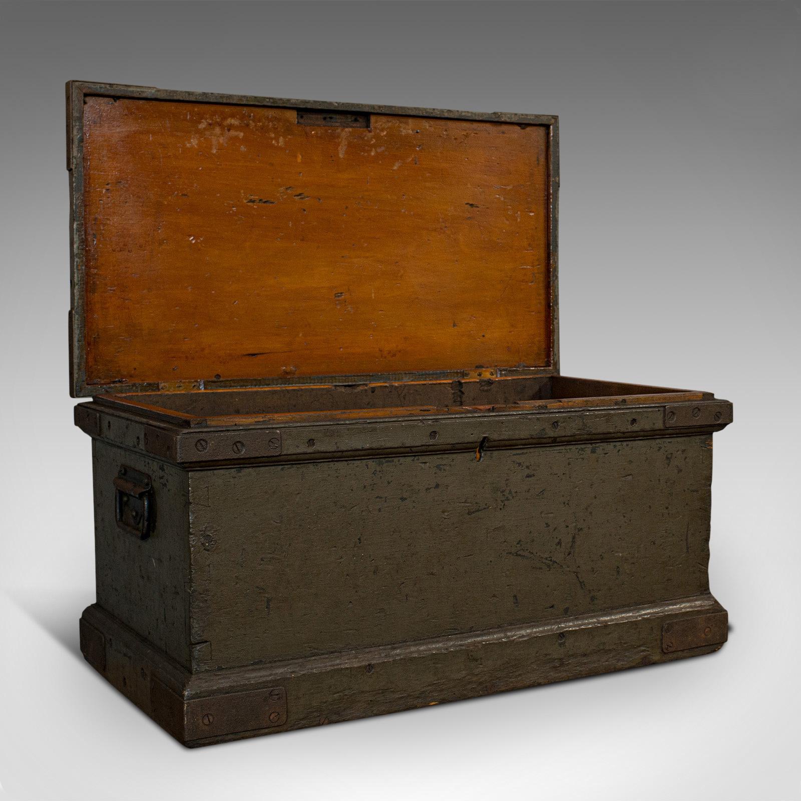 This is an antique workman's trunk. An English, pine carriage chest, dating to the Victorian period, circa 1880.

Appealing dark finish and solid feel
Displays a desirable aged patina
Stout pine stocks finished with deep charcoal hues
Flat top