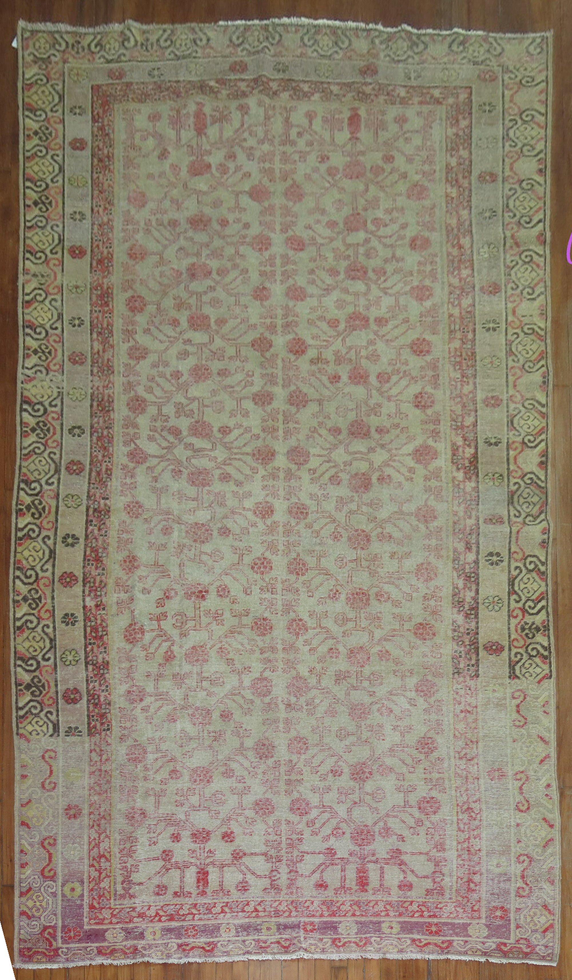 Gallery size worn Khotan rug from the 19th century with a pomegranate design.

Measures: 6'4'' x 13'2''.