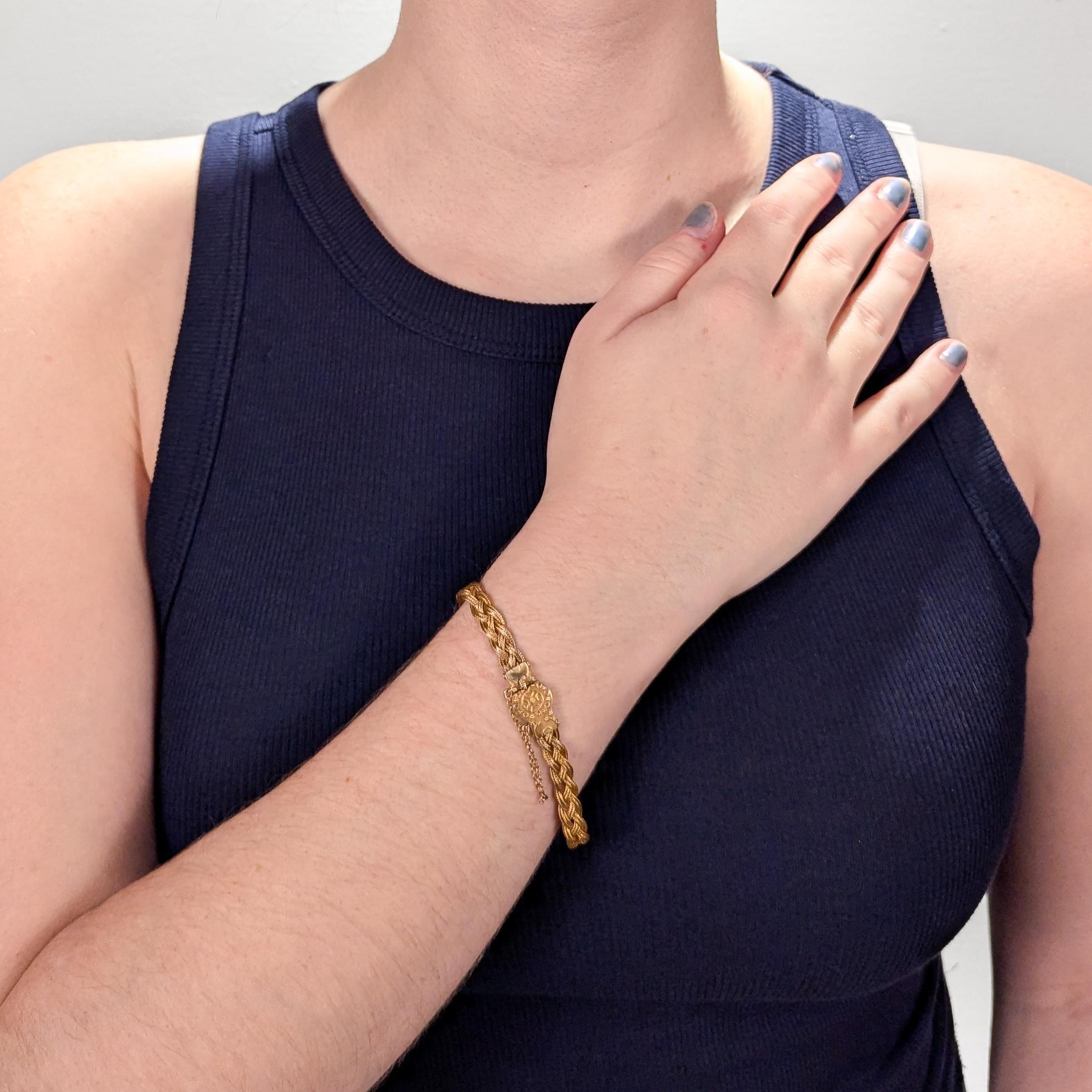 A very fine 14k gold Etruscan style bracelet.

With three delicate strands of woven braided gold wire terminating in an Etruscan style box clasp with granulated and wire work decoration. 

Set with a safety chain.

Simply a finely-made Etruscan