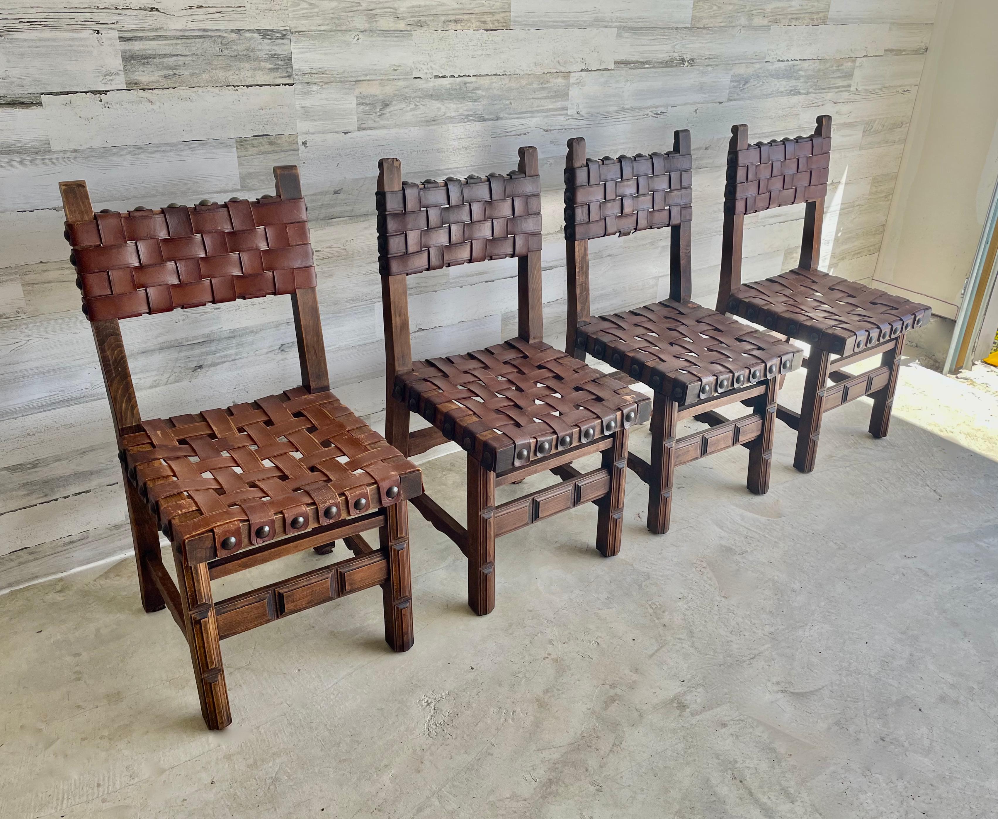 Antique woven leather dining chairs in the style of Navarro Argudo. These can work as dining chairs or side chairs.