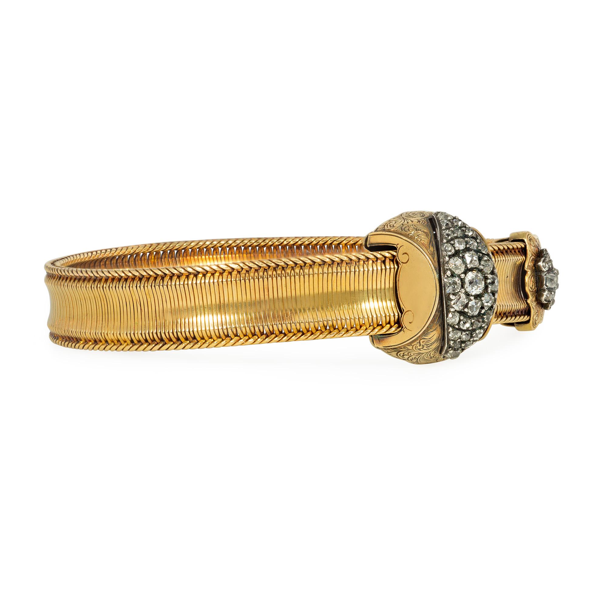 An antique Victorian period gold and diamond jarretière (garter) bracelet, the woven gold strap fitted through a gold buckle engraved with an arabesque design and set with diamonds in a radiating lozenge pattern, and terminating in a similarly