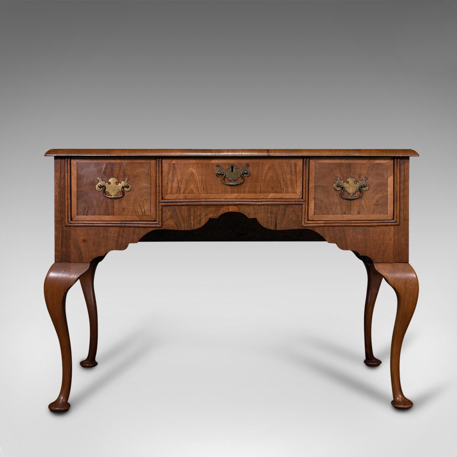 This is an antique writing desk. An English, burr walnut and oak lowboy or table, dating to the Georgian period, circa 1800.

Captivatingly figured and of superb elegance
Displays a desirable aged patina and in fine antique order
Burr walnut